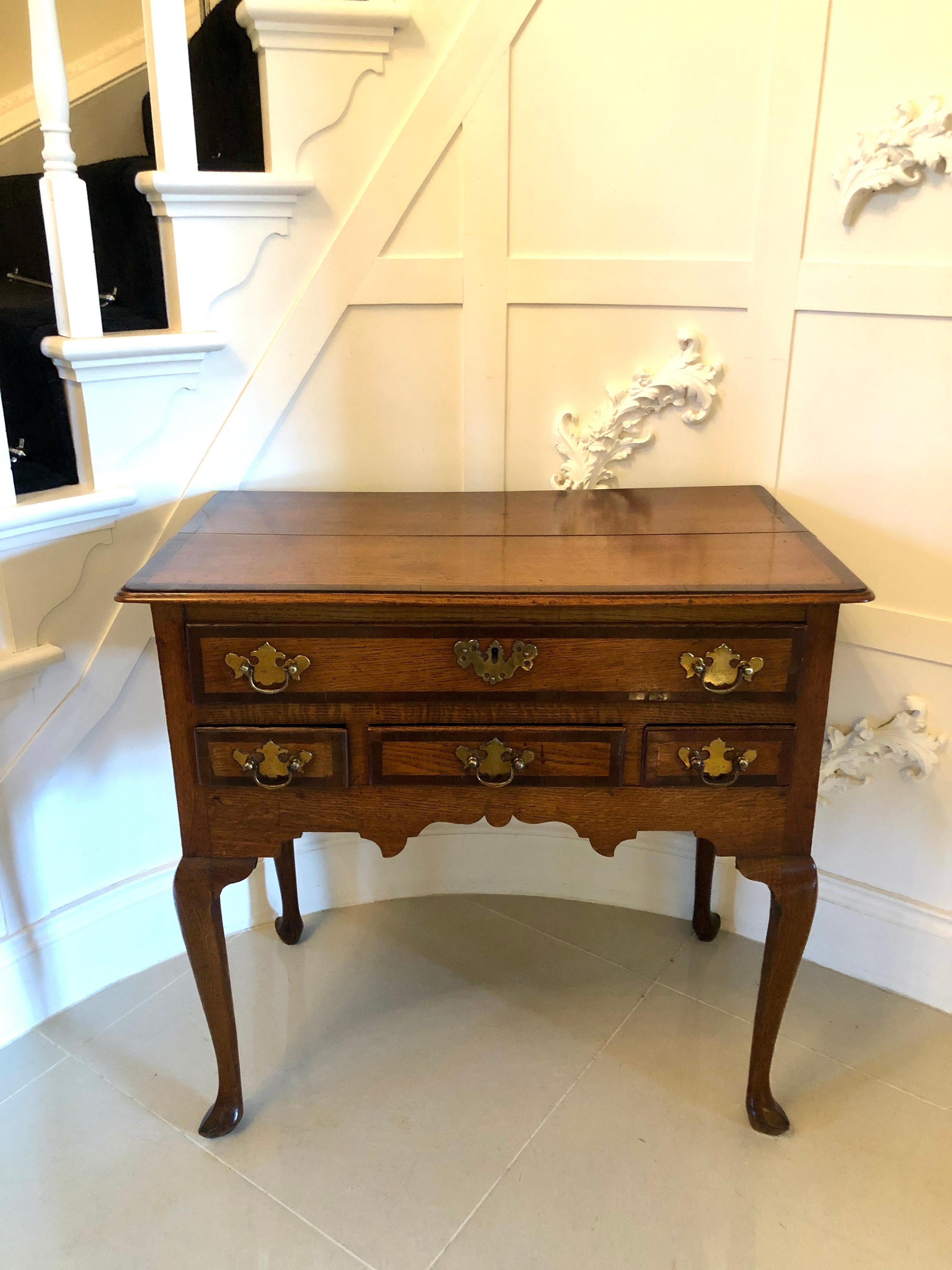 Antique George III oak lowboy

Antique George III oak lowboy having an oak top crossbanded in mahogany with a moulded edge. This handsome piece boasts one long drawer and three small drawers all crossbanded in mahogany with the original brass