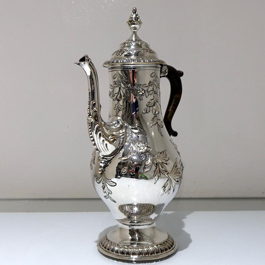 An early Rococo design mid-18th century Old Sheffield pear-shaped coffee pot decorated with splendid foliate embossing entwining the body. The pedestal foot has a gadroon outer border for decorative lowlights.

 

Measures: Height 12