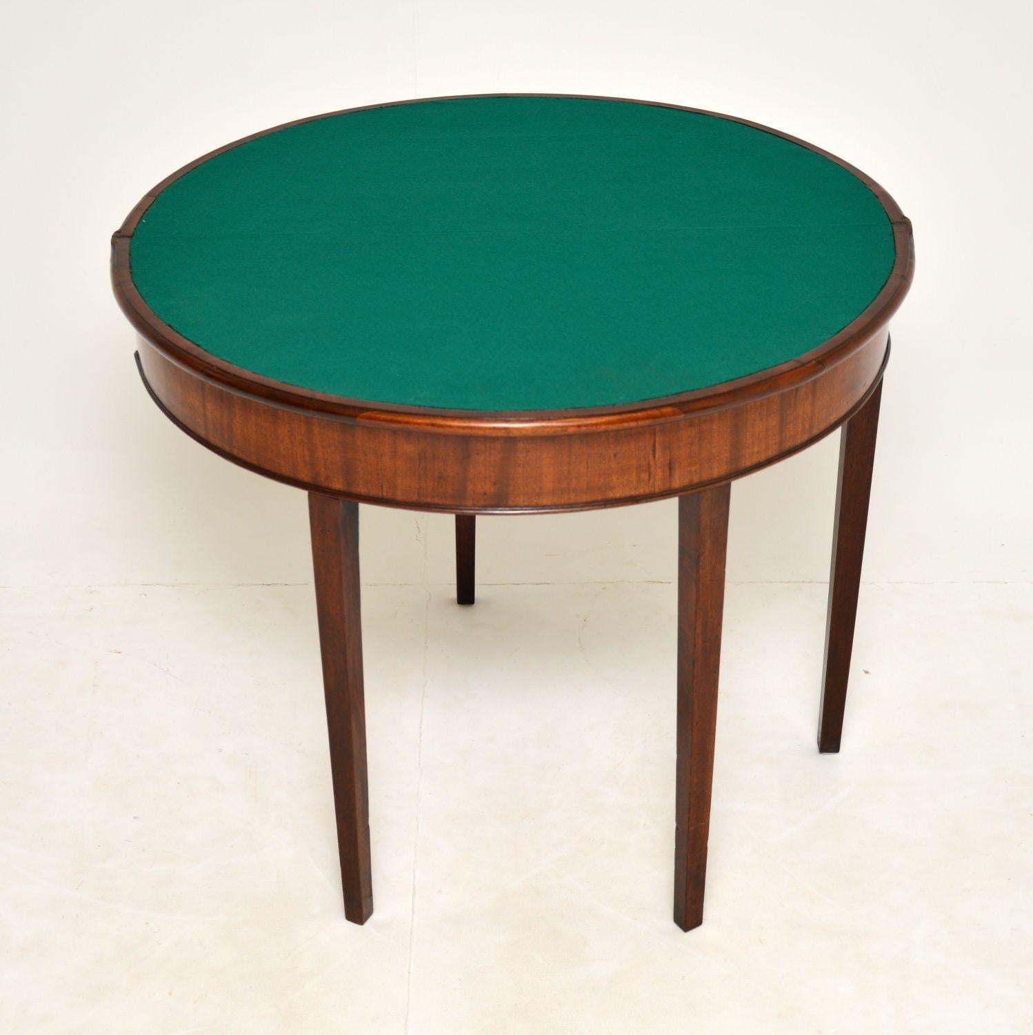 An elegant antique George III card table dating from around the 1790’s period.

It has a beautiful design and is a very useful shape. When closed it is perfect for use as a demi-lune console table. When opened it turns into a lovely circular card