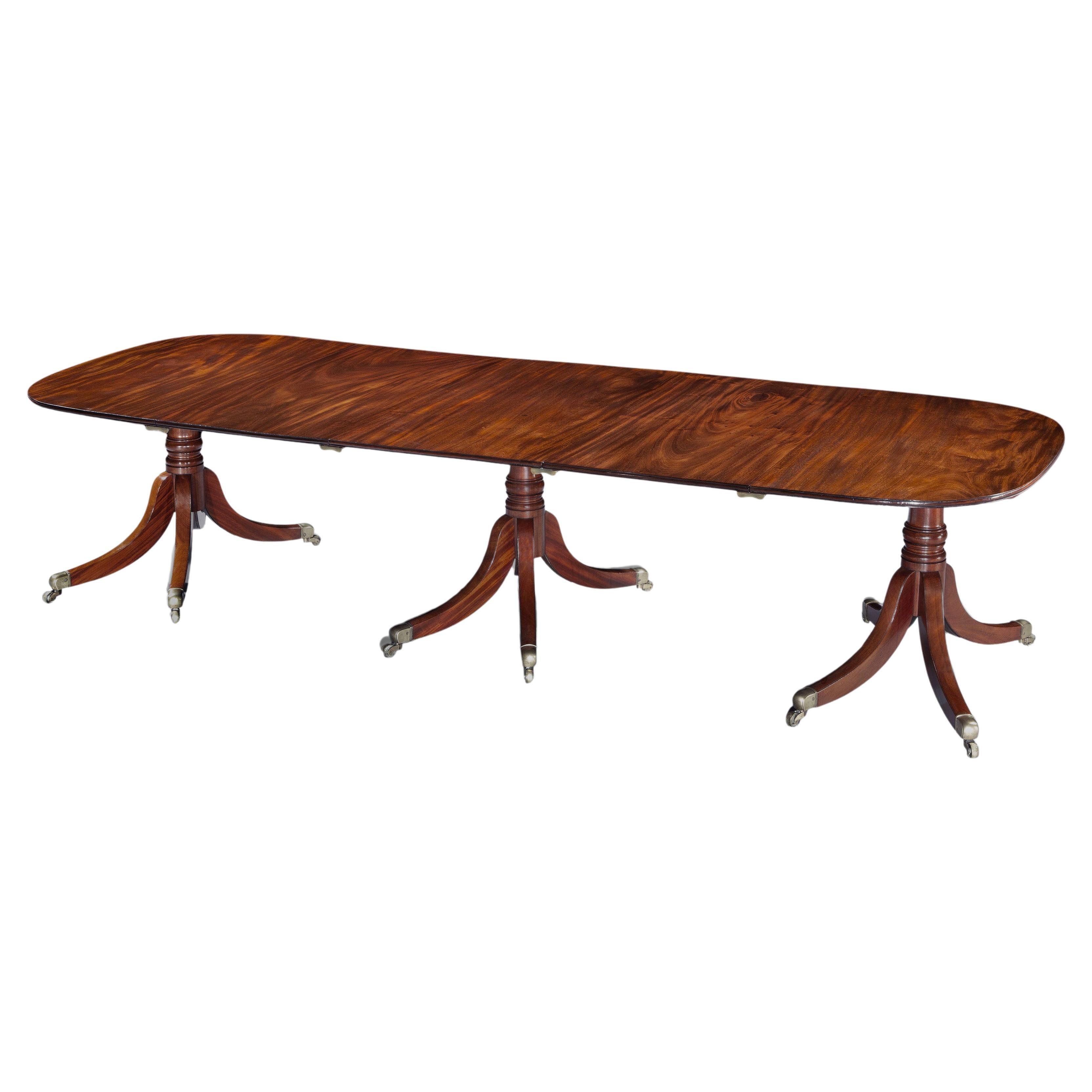 Antique George III period figured mahogany three pillar dining table