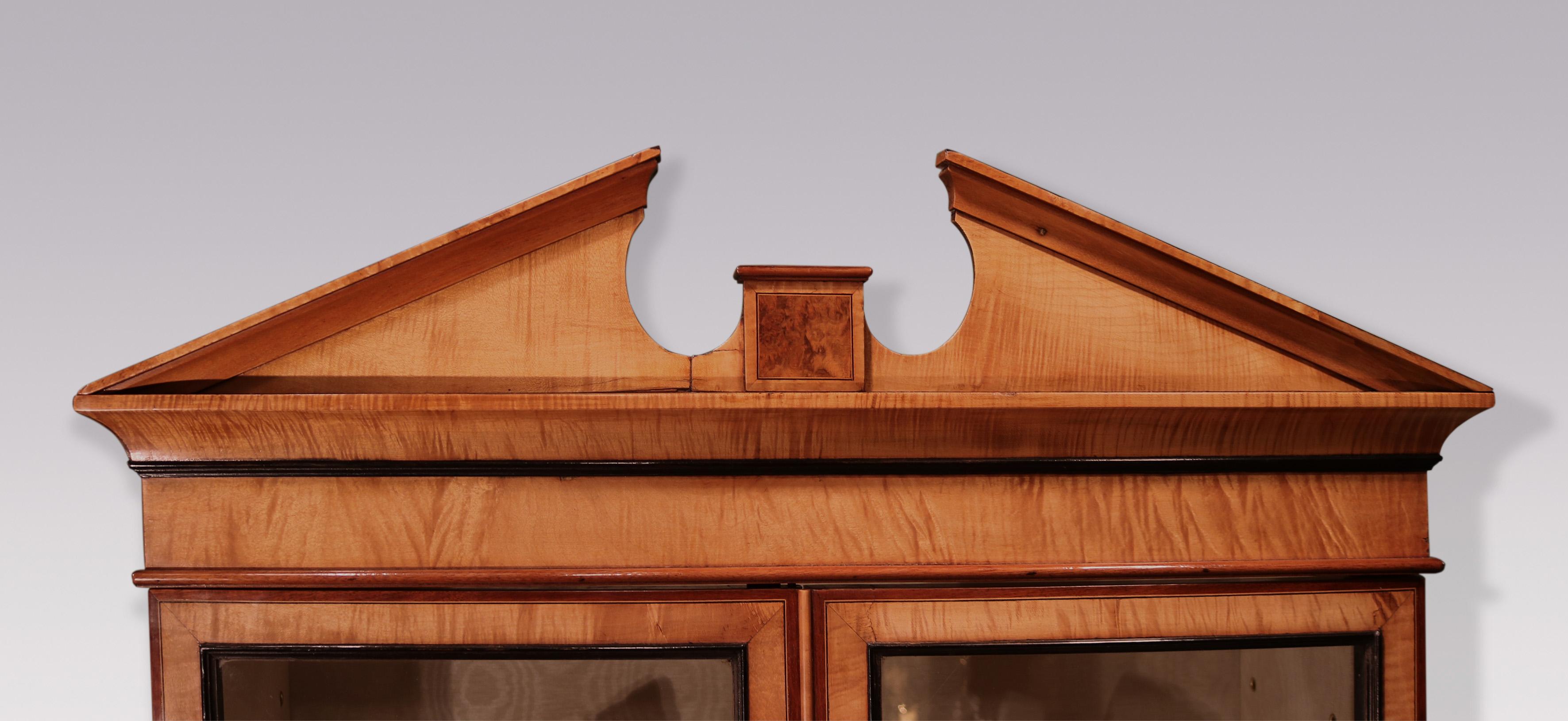 A late 18th Century Sheraton period harewood Display Cabinet on Stand, of unusual small proportions.  The piece, with yew-wood panels crossbanded throughout in purpleheart, having architectural pediment above glazed doors enclosing newly fitted