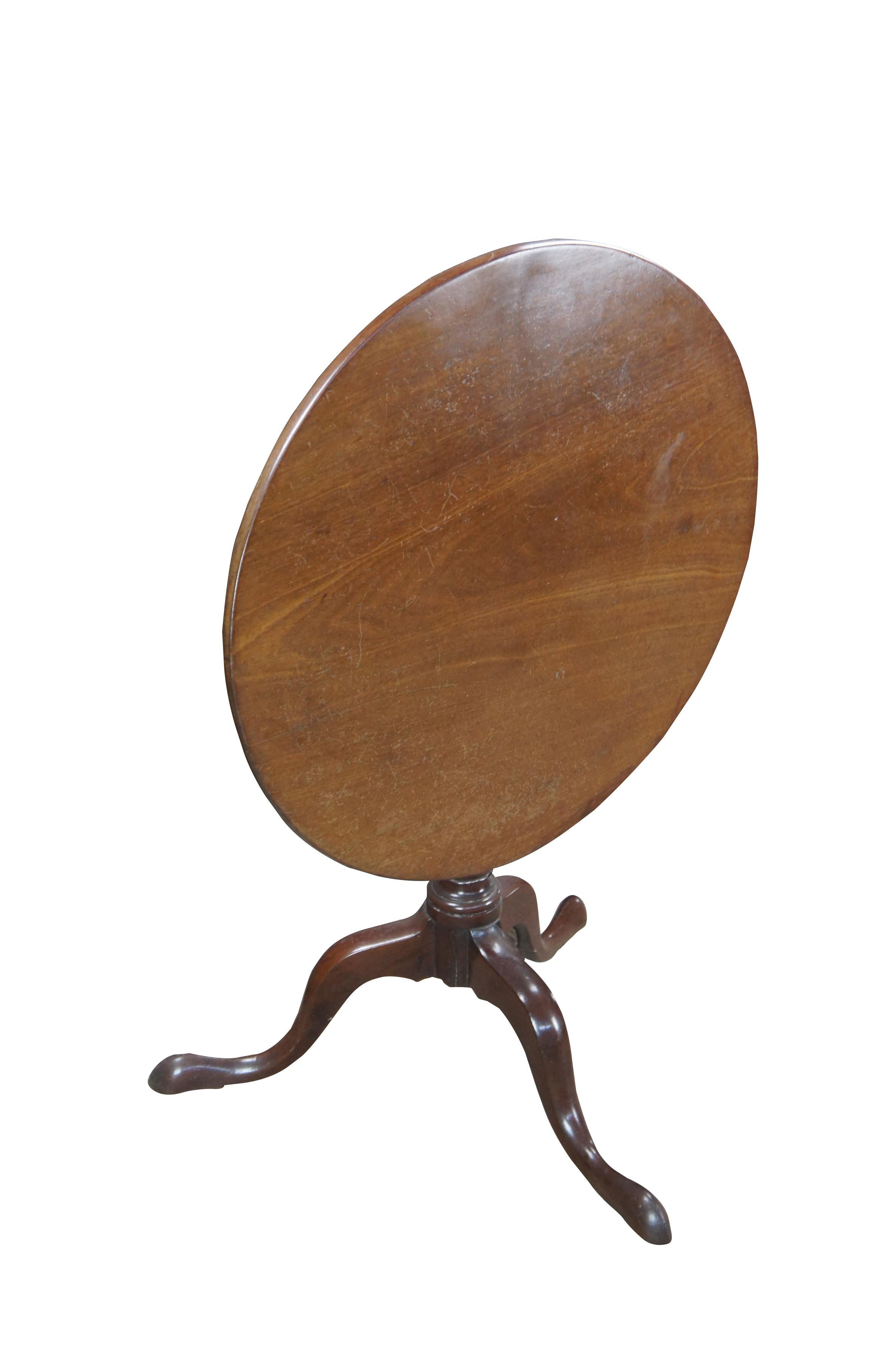 Exceptional early 19th Century George III Period Tilt Top Occasional Tea Table.  Made from solid mahogany with a round top over a birdcage baluster turned column terminating into a tripod base with downswept legs leading to slipper feet. 