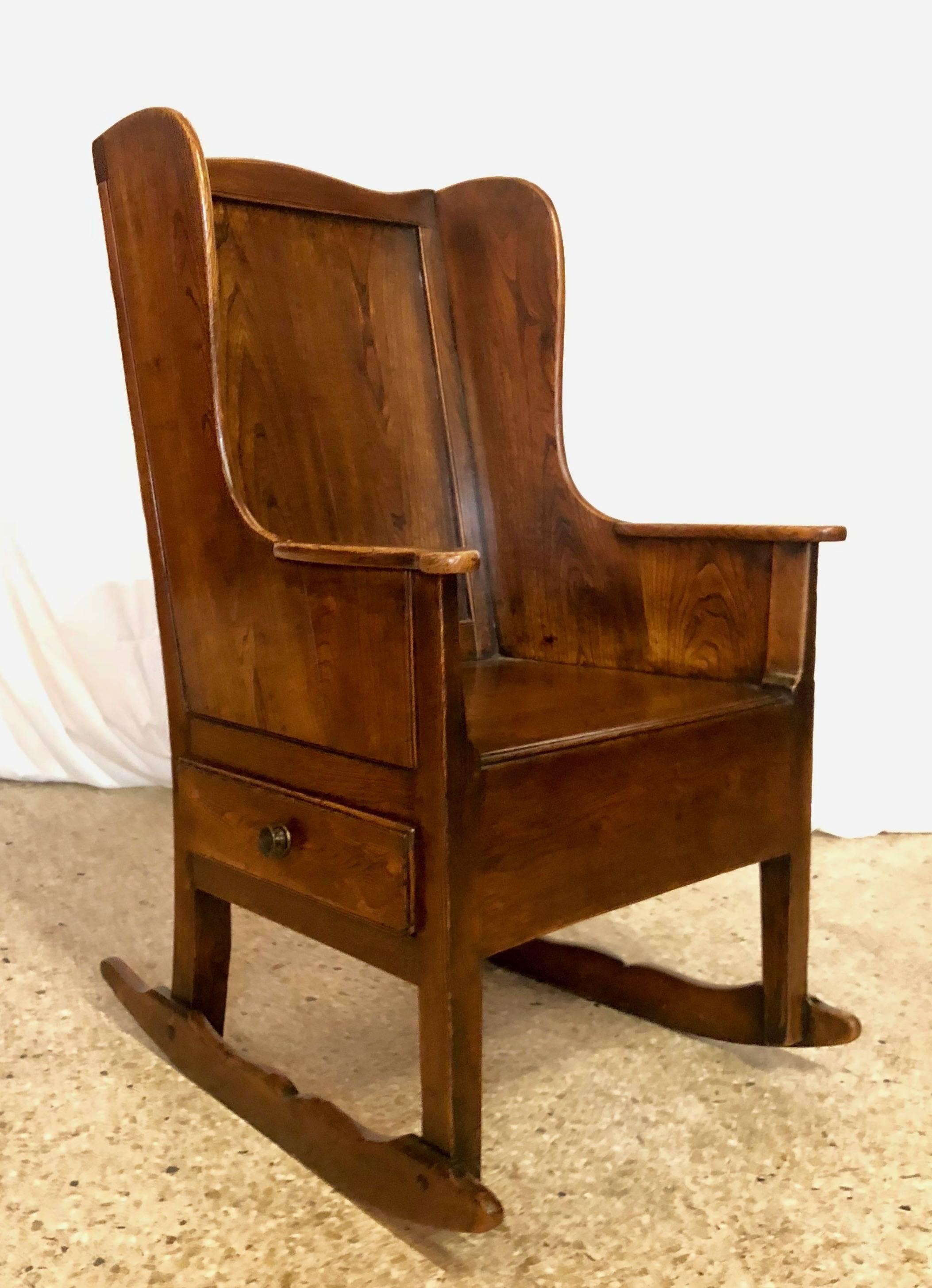 This sturdy, practially indestructible chair has a little drawer on one side, perfectly suited for storing that good book you are reading or knitting or anything else!