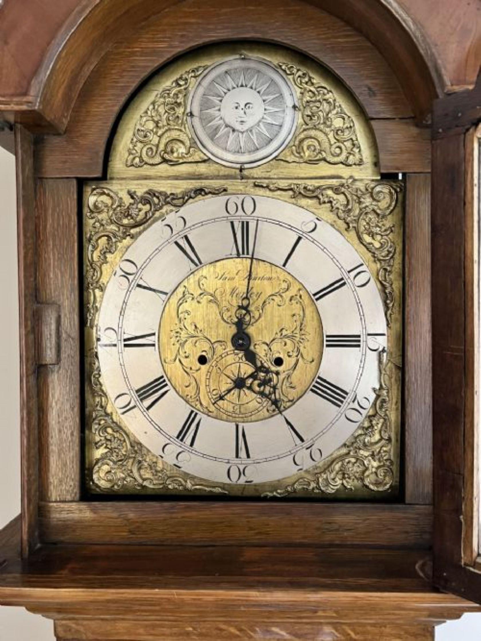 Antique George III quality 8 day brass face long case clock quality oak long case clock with a shaped pediment turned columns and a long door to the case. Outstanding brass arched dial silvered chapter ring with Roman numerals, original hands and a