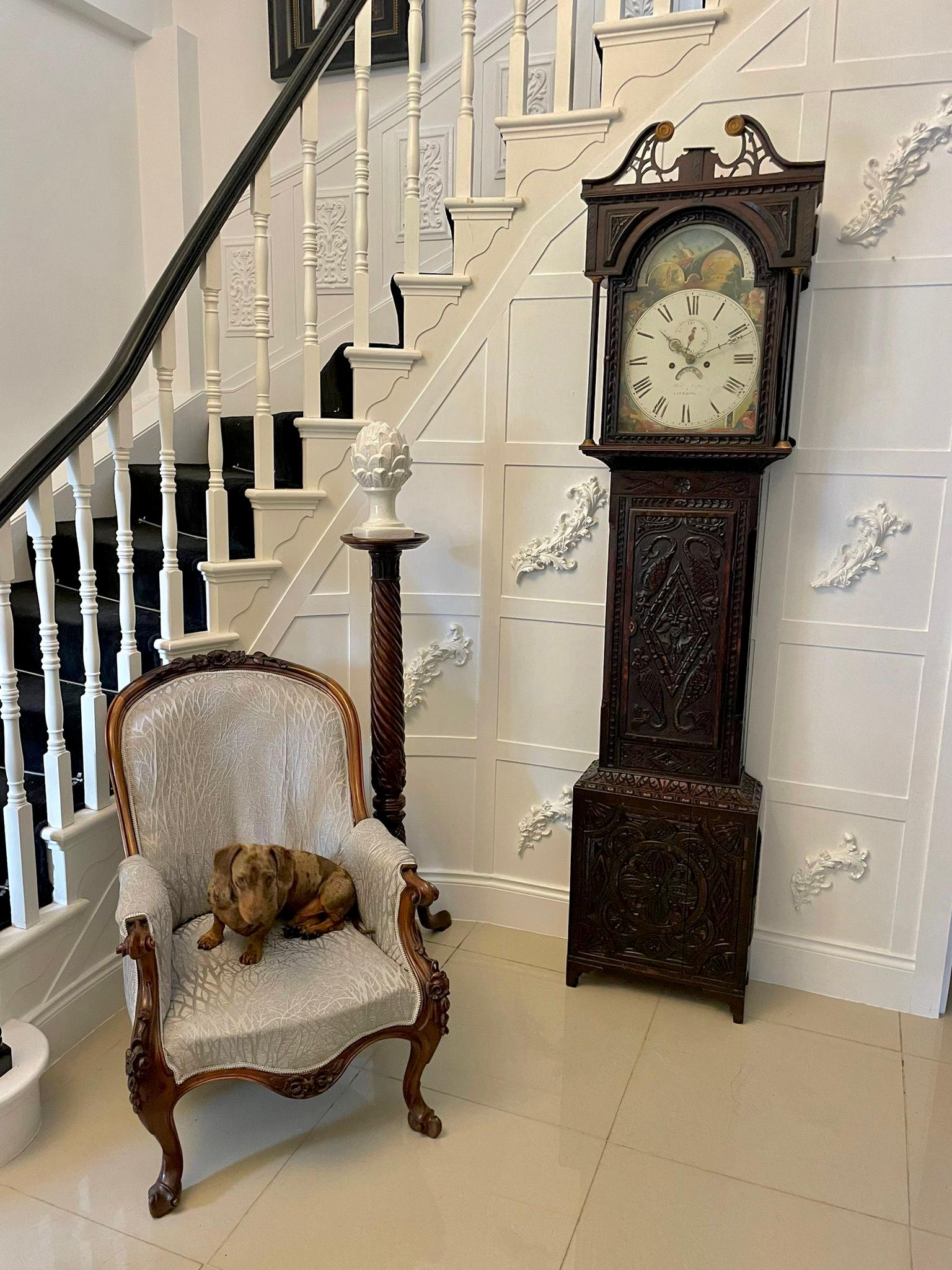 Antique George III quality carved oak moon phase longcase clock having a quality painted arched dial with a moon phase roller, 8 day movement striking on the hour and half hour on a bell, original weights and pendulum in a fantastic quality carved