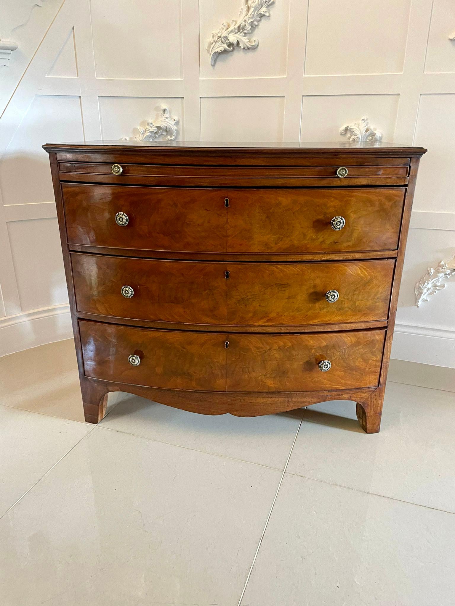 Antique George III quality figured mahogany bow front chest of 3 drawers having a quality figured mahogany bow front shaped top above a brushing slide, 3 figured mahogany bow fronted drawers with a cockbeeded edge and quality oak linings, brass