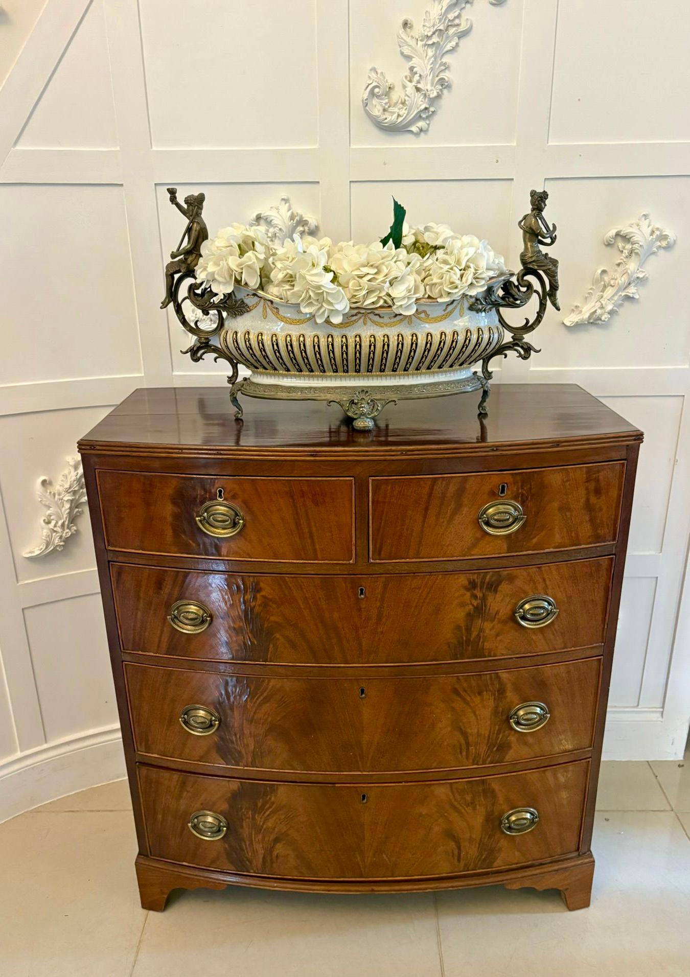 Antique George III quality figured mahogany bow fronted chest of 5 drawers having a quality figured mahogany bow fronted shaped top with a moulded edge above 2 short and 3 long figured mahogany oak lined cockbeaded drawers with oval brass handles