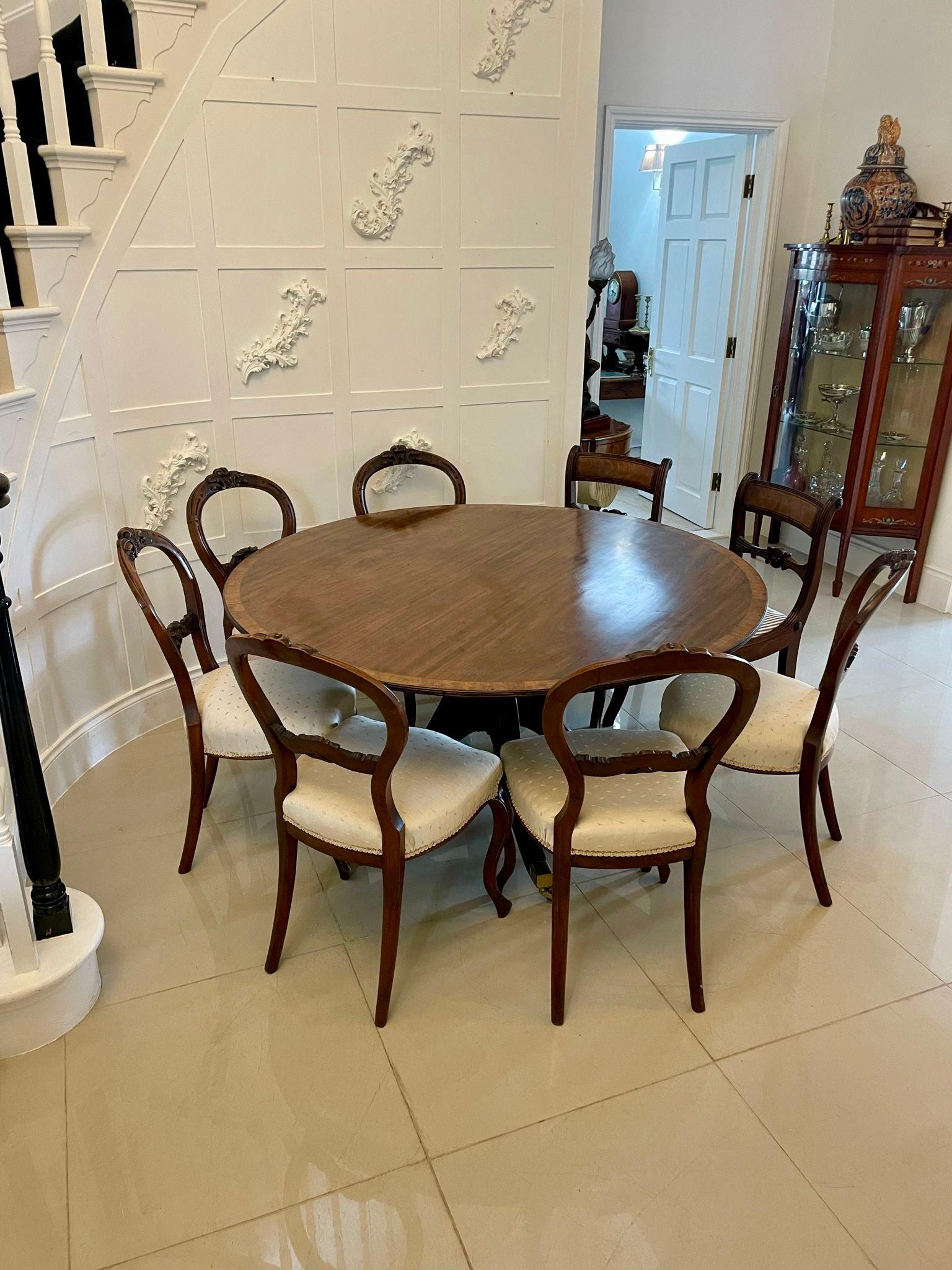 Antique George III quality figured mahogany circular dining table having a quality figured mahogany satinwood crossbanded circular top supported by a turned pedestal column standing on four reeded sabre legs with original brass castors


A handsome