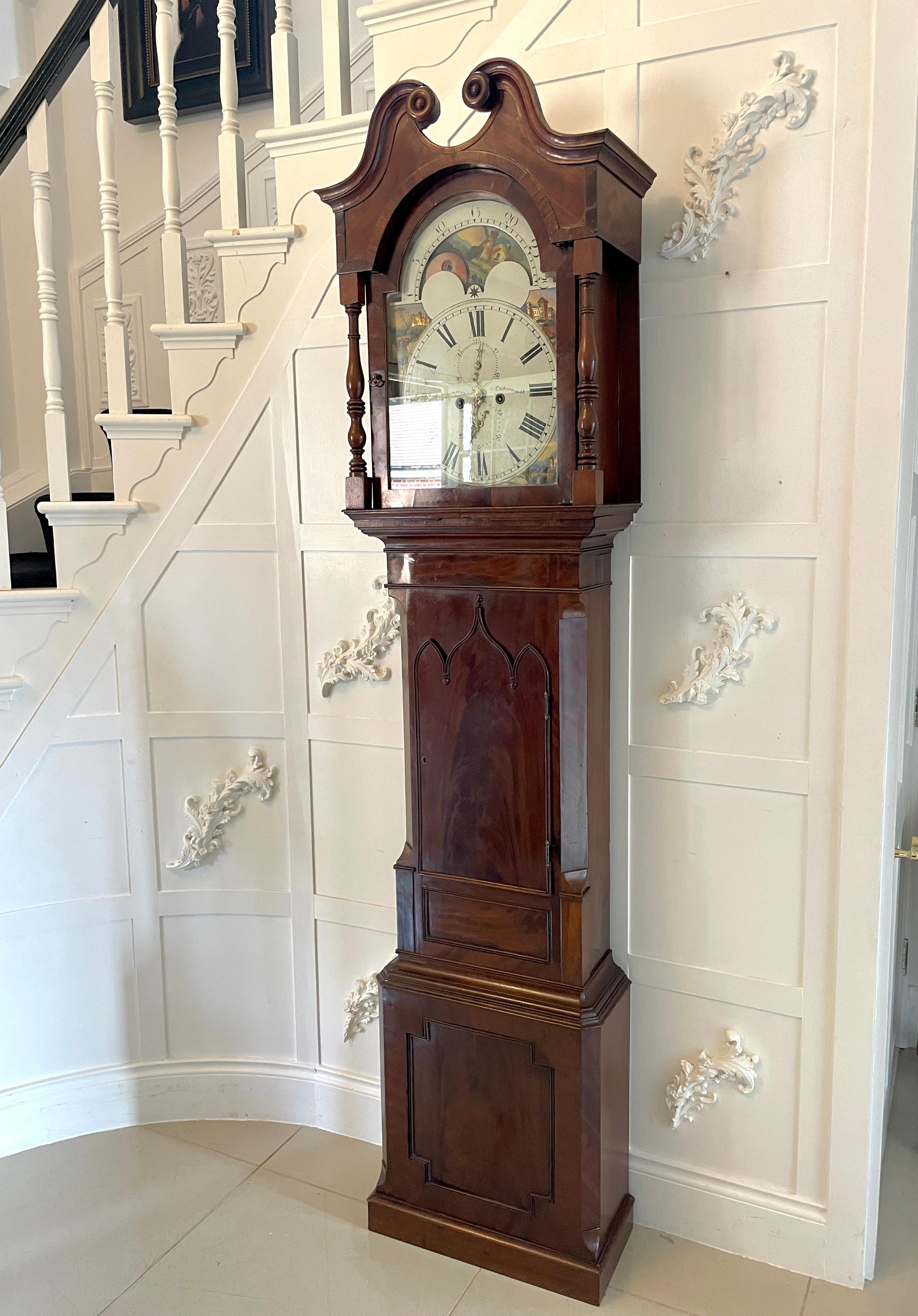Antique George III quality mahogany 8 day longcase clock having a quality mahogany case with a swan neck pediment, turned columns, mahogany and glass arched shaped door opening to reveal a pretty painted dial with a moon phase in the arch top, 8 day