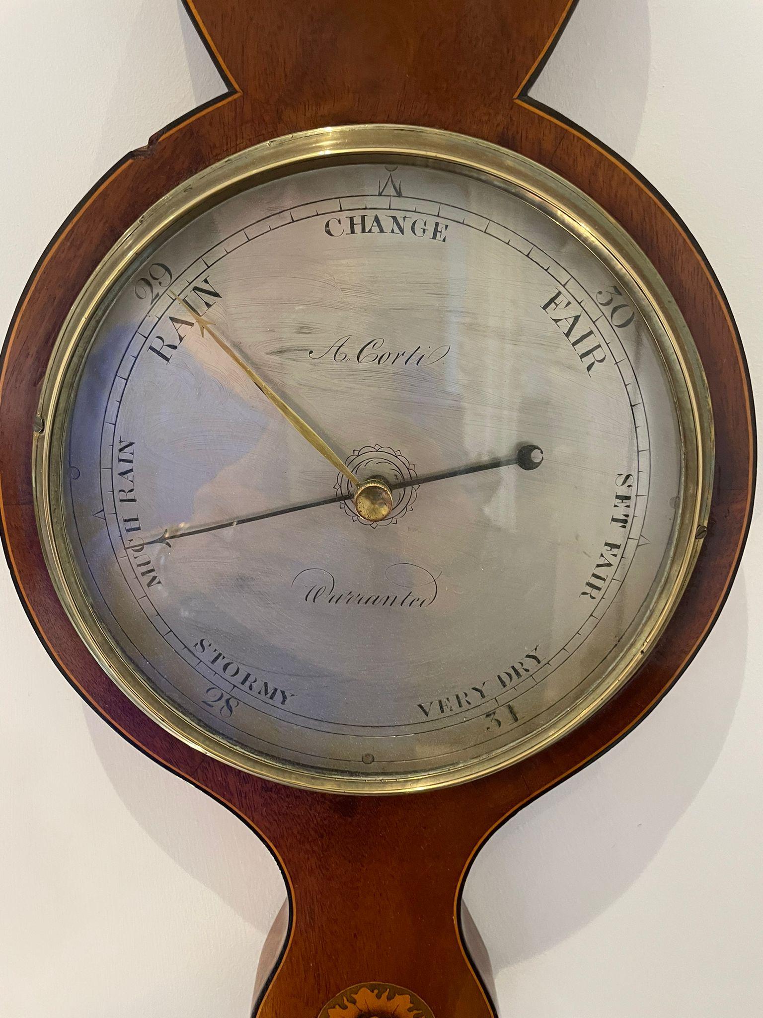 Antique George III quality mahogany banjo barometer having a swan neck pediment, original thermometer and an engraved circular silvered dial with original hands and brass bezel, quality mahogany inlaid case with oval shells and starburst with