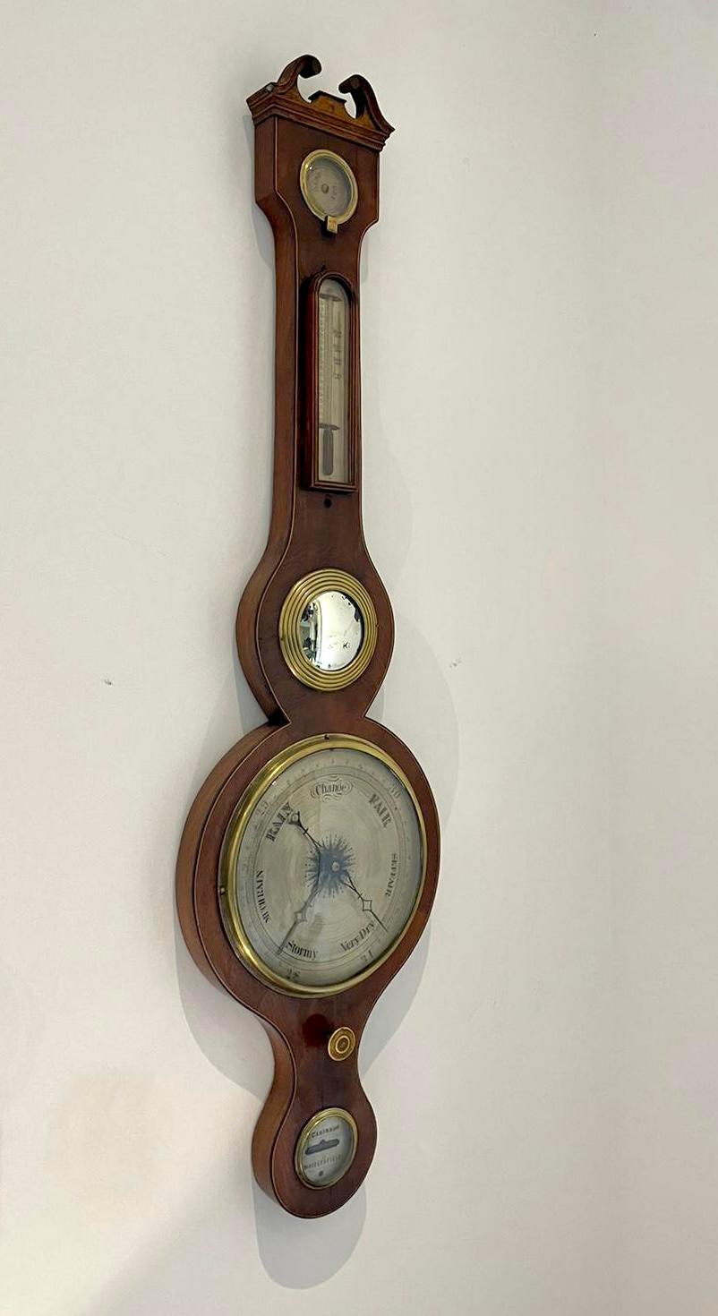 Antique George III quality mahogany banjo barometer having a quality mahogany shaped case with a swan neck pediment and satinwood stringing, circular silvered engraved dial with original hands and bezel, thermometer, fitted hygrometer, circular