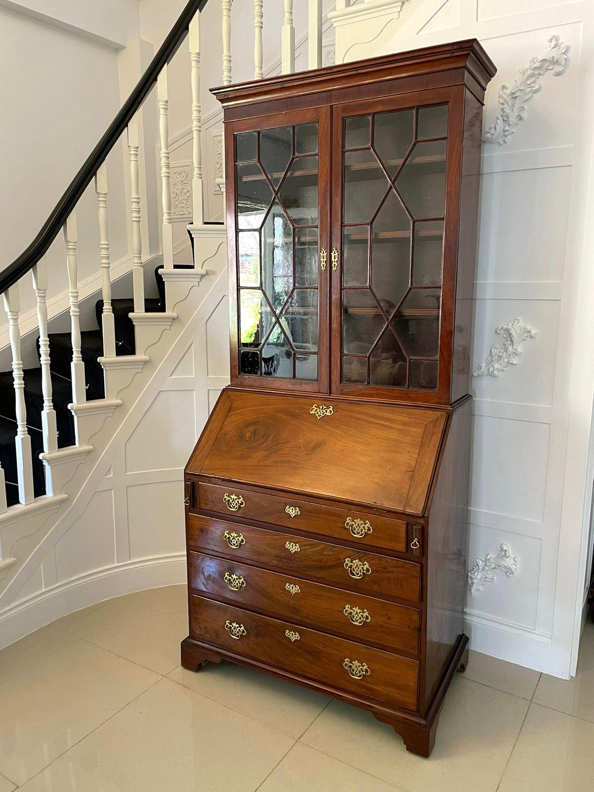 Antique George III quality mahogany bureau bookcase having a shaped moulded cornice with a mahogany frieze above a pair of quality mahogany astral glazed doors opening to reveal three shelves and boasts the attractive original brass escutcheons. The