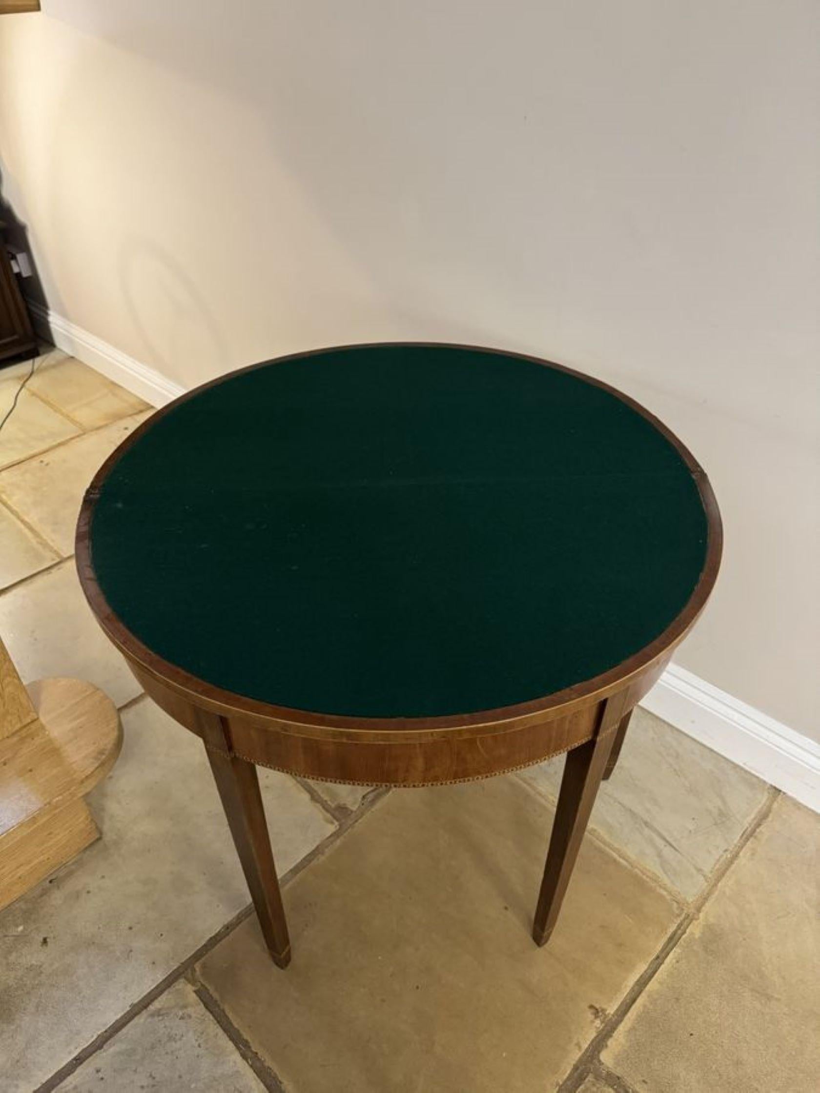 Antique George III quality mahogany card table, having a quality mahogany top with satinwood inlaid stringing opening to reveal a baize interior, mahogany frieze with satinwood inlay, standing on square tapering legs.

Table open:
W 91cm
D 91cm

D.