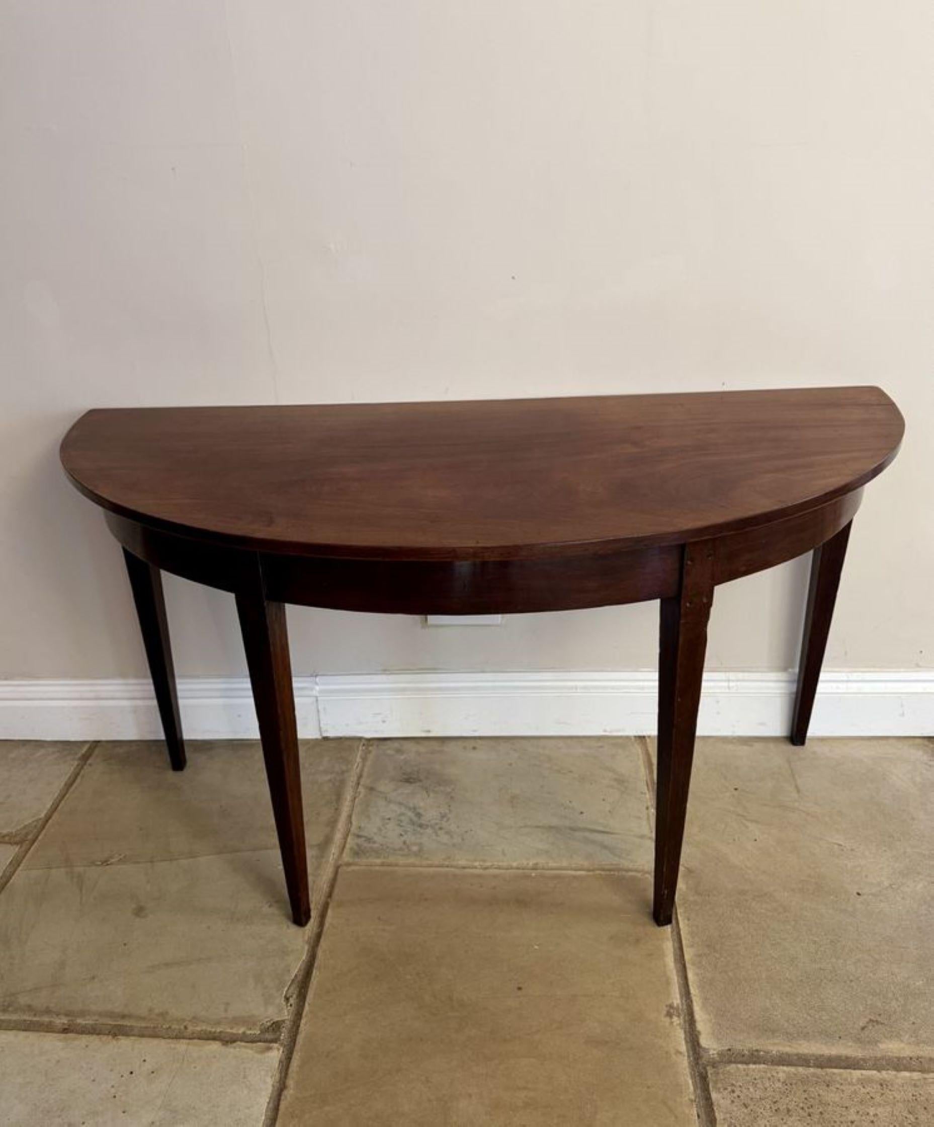 Antique George III quality mahogany demi lune shaped console table, having a quality mahogany Demi lune shaped top standing on four tapering legs.

D. 1800