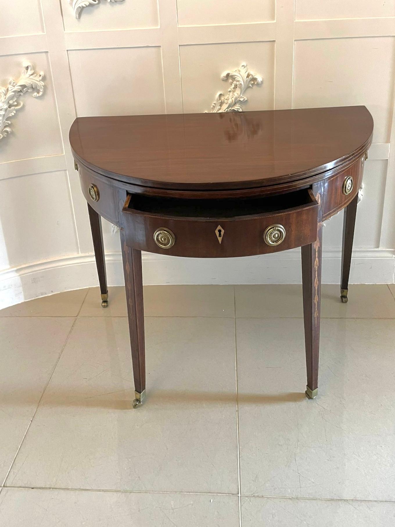 Antique George III quality mahogany Demi lune shaped tea/console table having a quality demi lune shaped fold over top opening to reveal a polished interior above a single drawer flanked by two dummy drawers with original brass ring handles standing