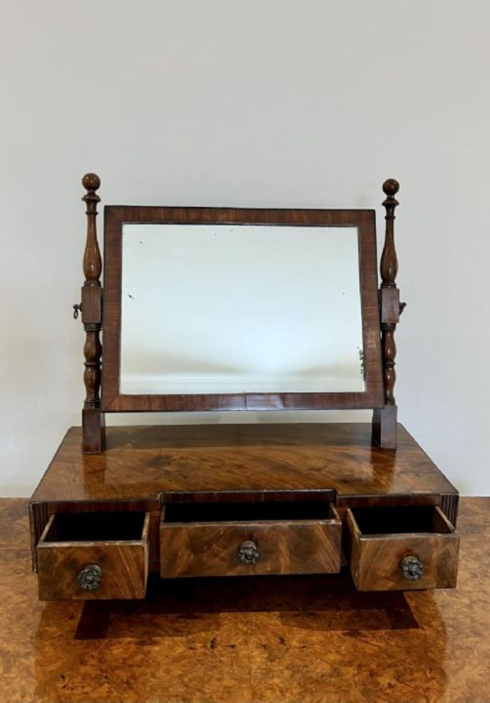 Antique George III quality mahogany dressing mirror having a quality rectangular shaped tilting mirror supported by turned mahogany columns above a mahogany base with three drawers, original brass knobs standing on original turned feet 