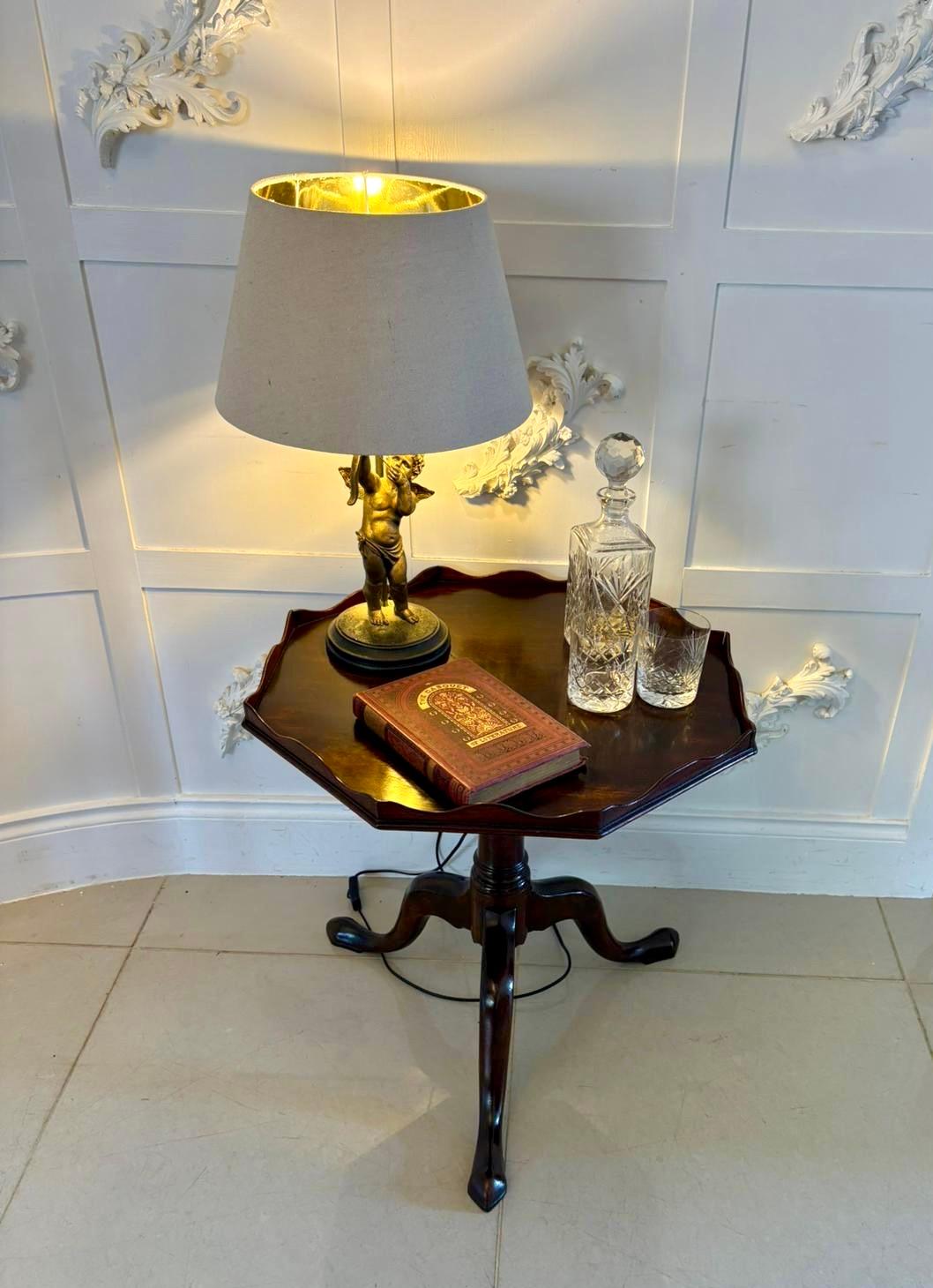 Antique George III quality mahogany lamp/coffee table having a quality mahogany hexagonal shape top with the original shaped gallery supported by a turned tapering column standing on three shaped cabriole legs with pad feet.

A charming table