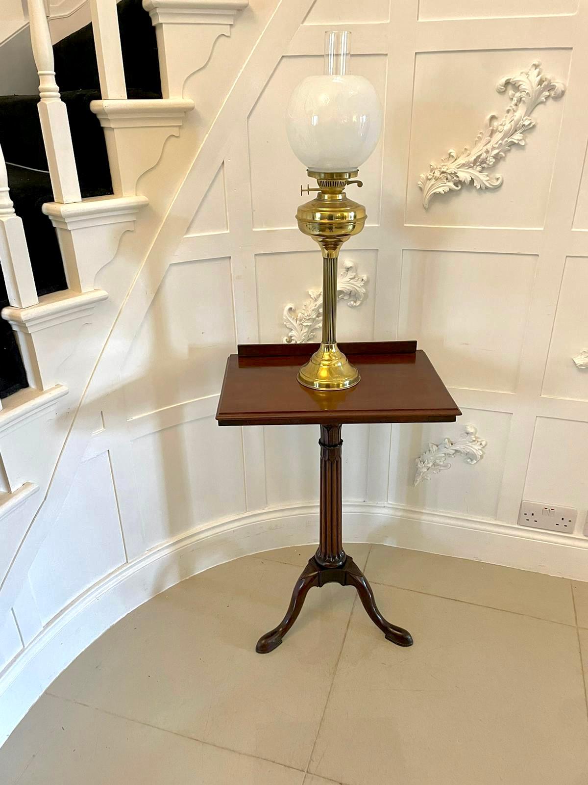 Antique George III quality mahogany tripod reading/lamp table having a quality mahogany adjustable top which can be laid flat supported by an elegant fine reeded tapering pedestal column standing on shaped cabriole legs with pad feet 

A quaint