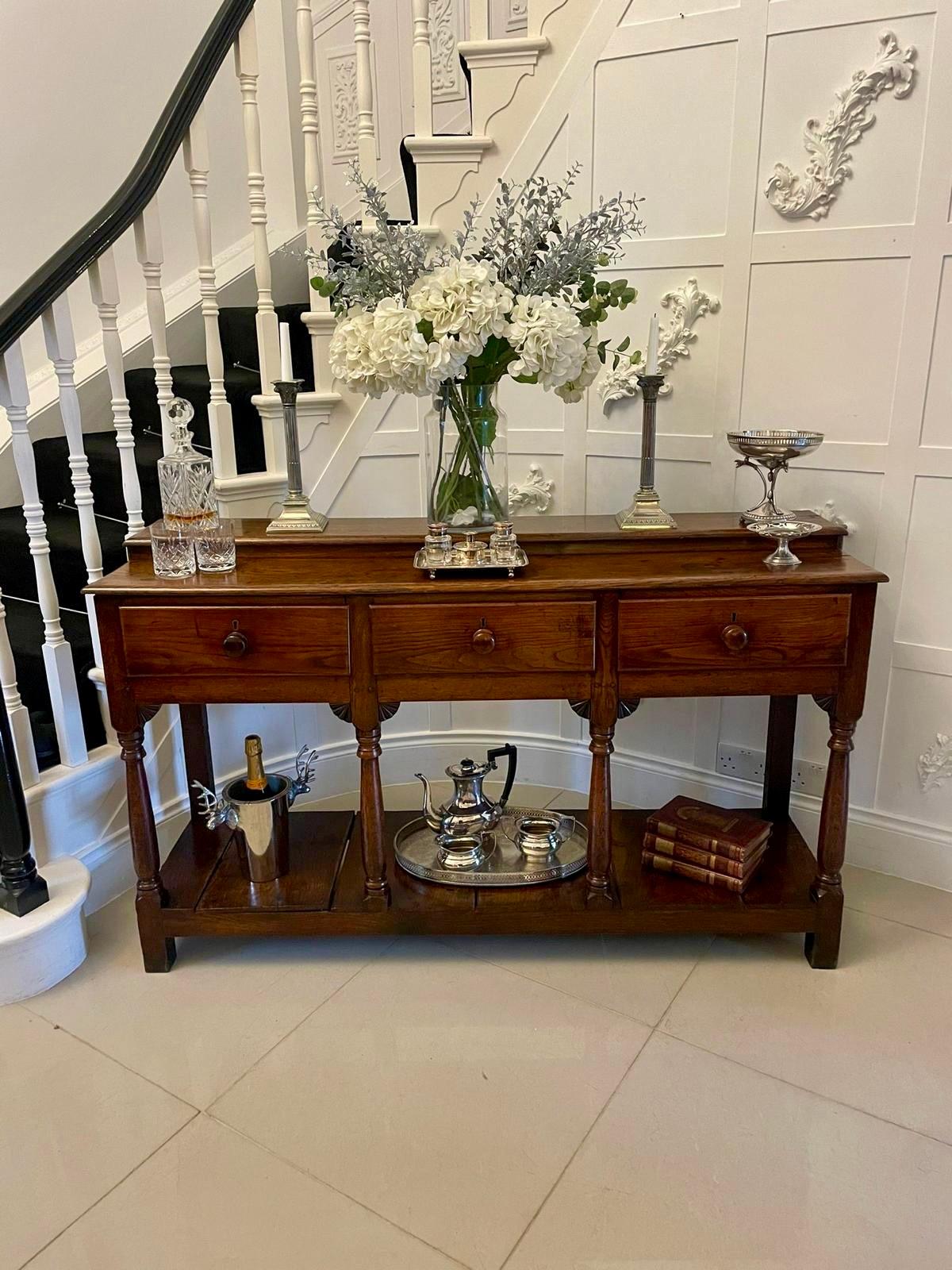 Antique George III quality oak dresser base having a quality oak rectangular shaped top above three long drawers supported by turned oak columns with carved brackets. It boasts a fabulous pot board base raised on original feet 


A wonderful