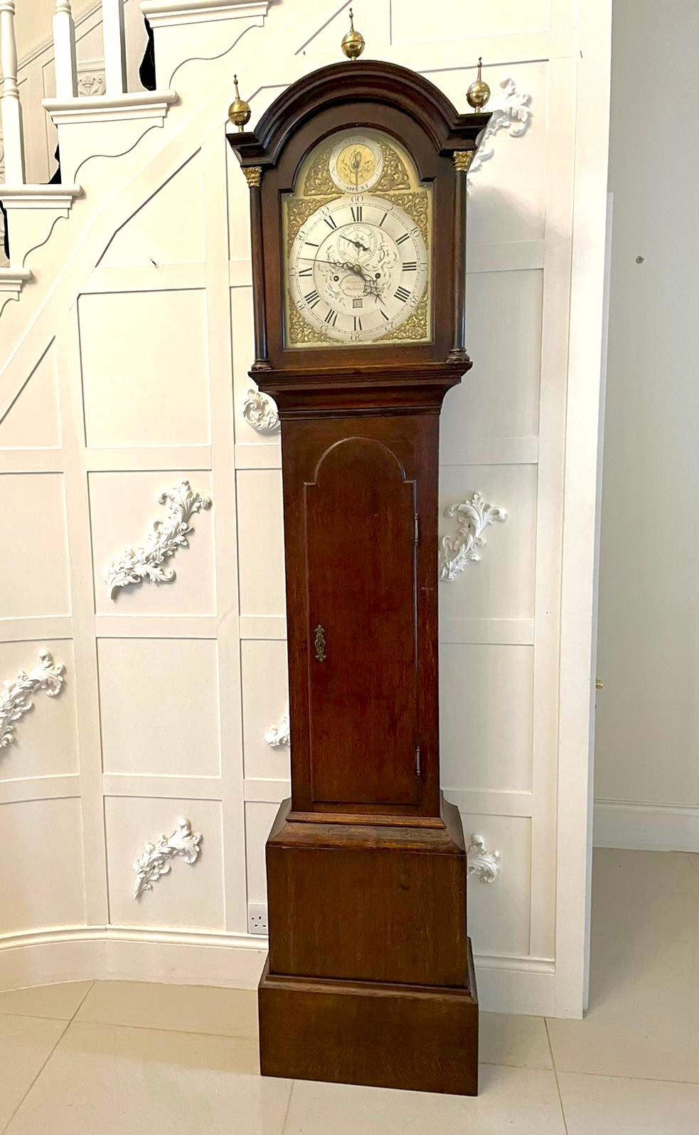 Antique George III quality oak longcase clock by Henry Frost Philmoorehill having a removable arched hood with a shaped cornice and three brass finales, glazed door flanked by two turned columns with ornate brass capitals, long shaped door to the