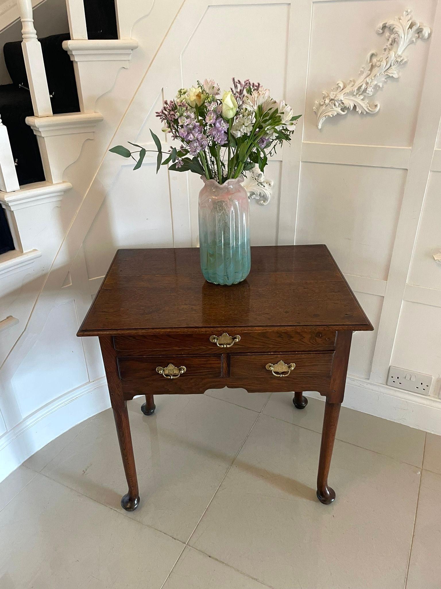 Antique George III quality oak lowboy having a quality oak rectangular shape top with a moulded edge above one long and two short drawers with original engraved brass handles standing on turned tapering legs with pad feet 


A handsome example