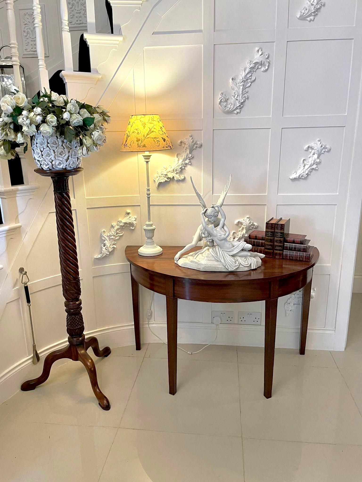 Antique George III quality pair of mahogany demi-lune console tables having quality mahogany shaped Demi- lune tops above a moulded frieze standing on square tapering legs.

H 72cm
W 118cm
D 59cm 
Date 1800.


 