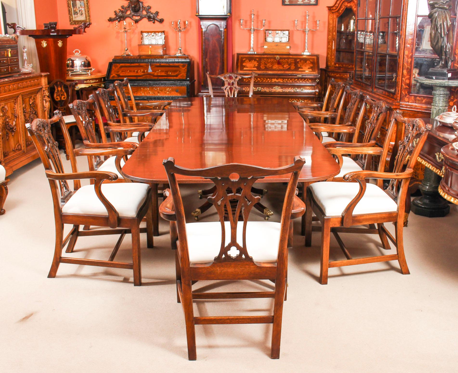 This is an elegant dining set comprising an antique George III Regency Period dining table, Circa 1820 in date, with a fabulous set of ten Chippendale Revival armchairs.

The table is raised on three bases each with turned pillars on sabre legs,
