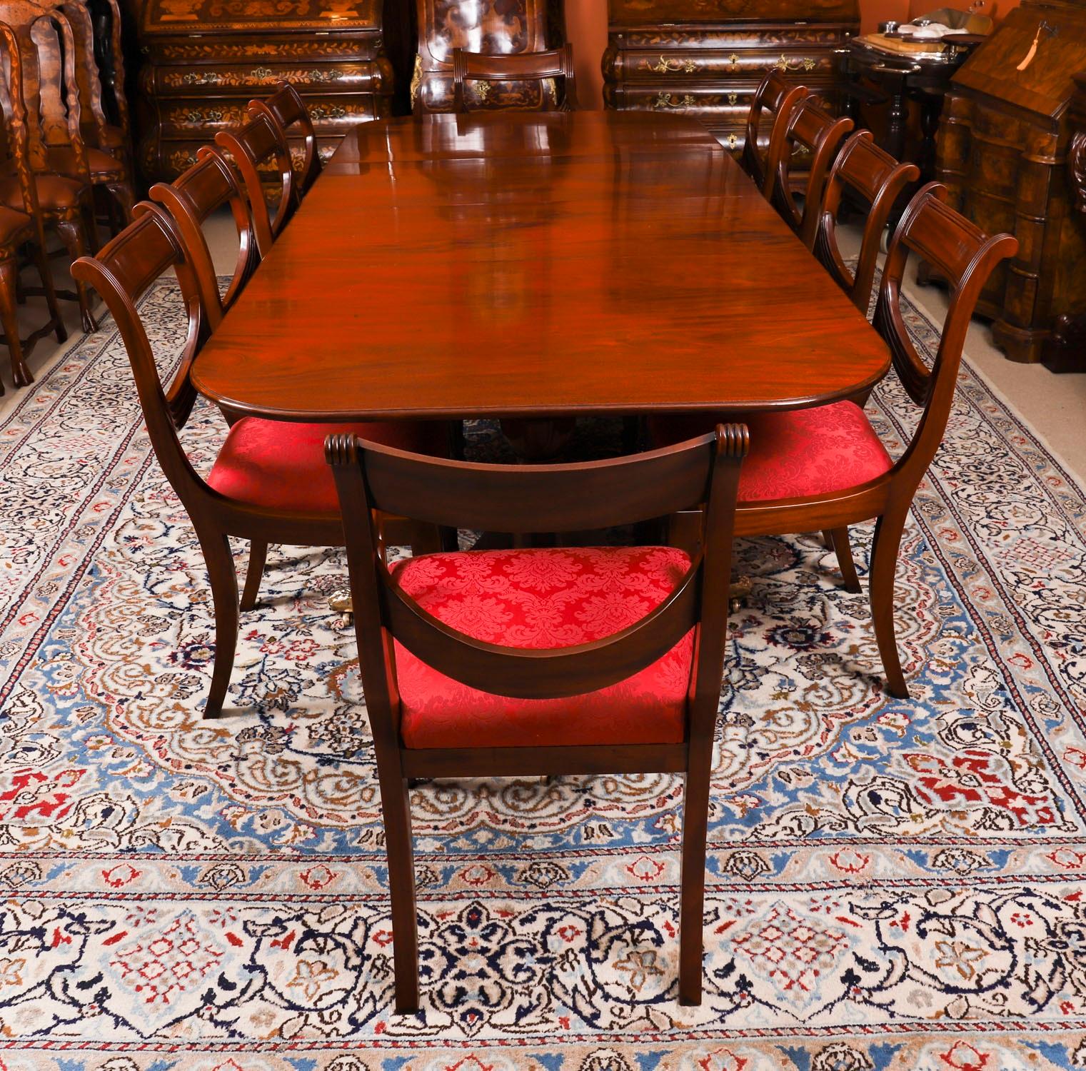 This is an elegant dining set comprising an antique George III Regency Period dining table, Circa 1820 in date, with a fabulous set of eten Swagback dining chairs.

The table has two additional leaves and is raised on twin 