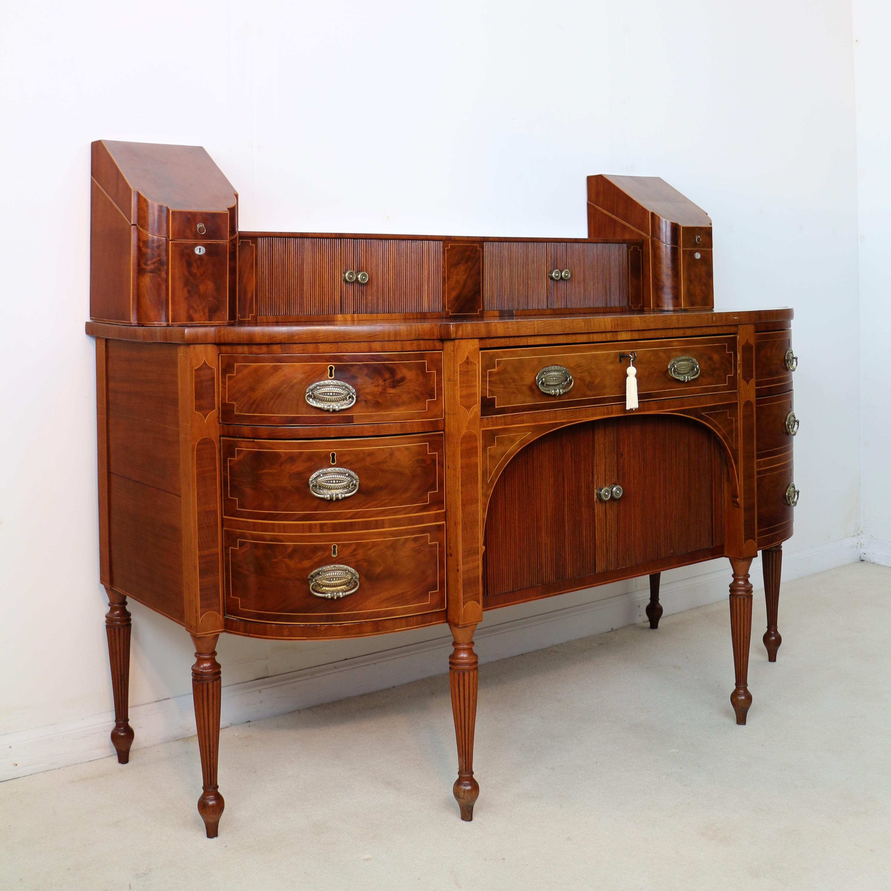 An outstanding George III Scottish flame mahogany stage-back sideboard with original knife boxes and dating to circa 1800, probably Edinburgh. Highlighted with plentiful boxwood stringing to the front and sides, the stage has a central inlaid tablet