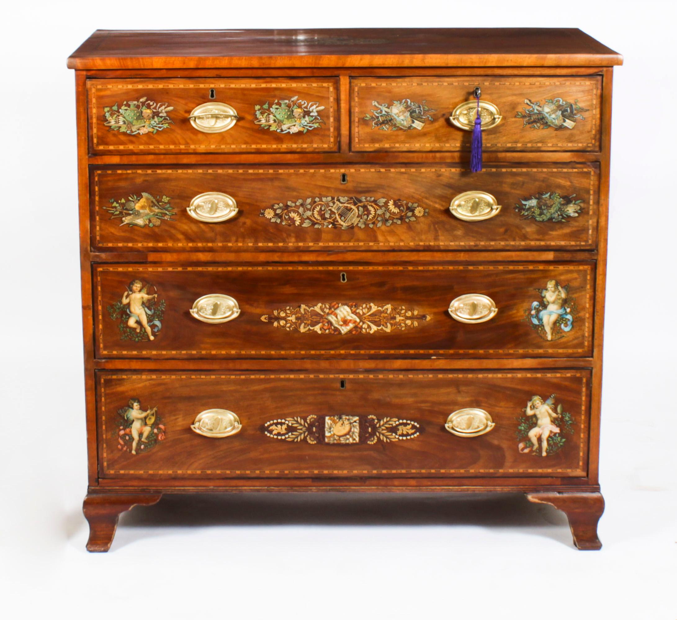 This is beautifully crafted antique George III painted mahogany chest of drawers, in the Sheraton manne, and circa 1780 in date.
 
The top features a painted musical trophy in the centre with chequer banding.
 
The two half width and the three