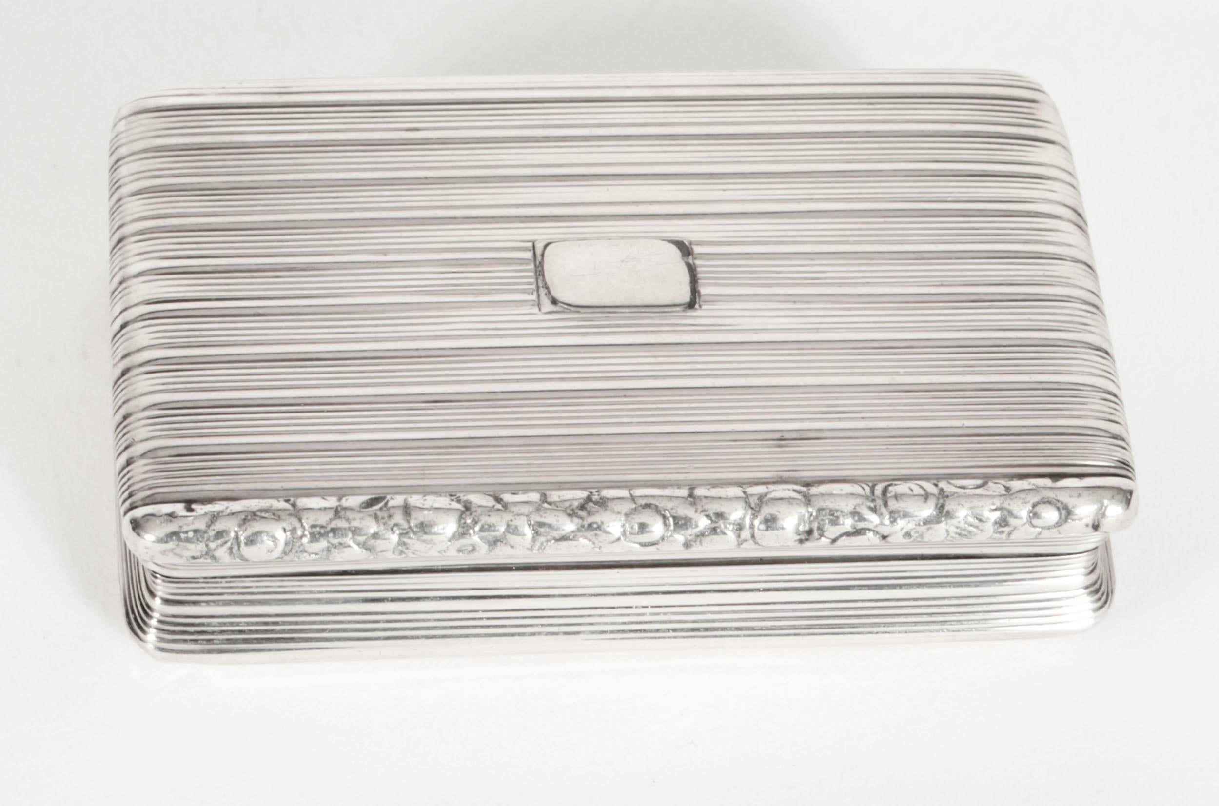 This is an exquisite antique George III sterling silver snuff box, with hallmarks for Birmingham 1817, of rectangular form with reeded decoration, vacant cartouche, moulded front rim, opening to reveal a gilt interior
 
There is no mistaking its
