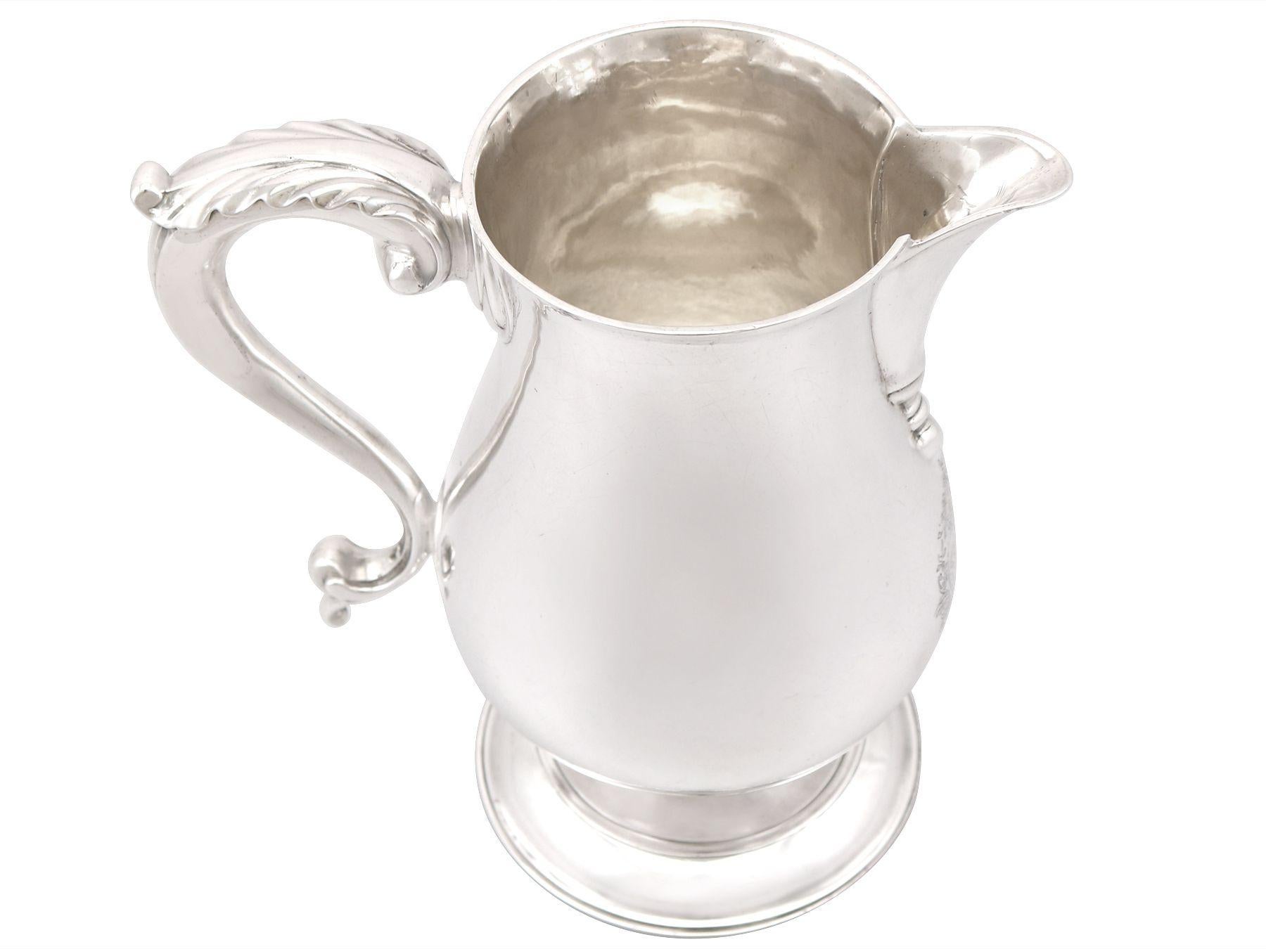 An exceptional, fine and impressive antique George III English sterling silver beer/water jug; part of our dining silverware collection

This exceptional antique Georgian sterling silver beer jug has a plain baluster form onto a circular spreading
