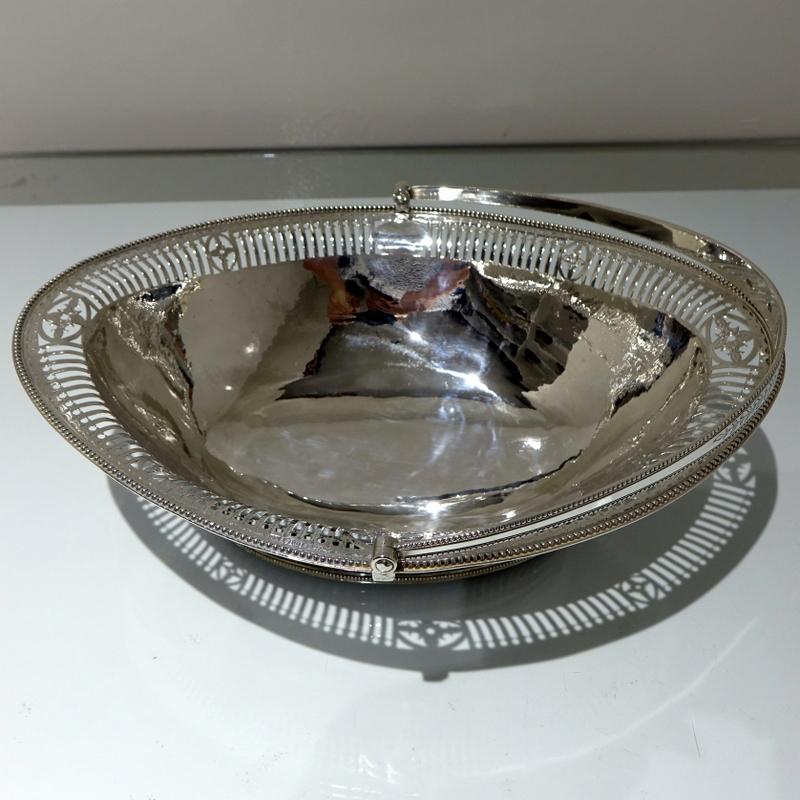 A delightful large oval swing handled cake basket made by the highly collectable silversmith Hester Bateman. The basket has an elegant outer hand pierced gallery and a applied bead wire for decorative highlights.

Weight 26.4 troy ounces / 824