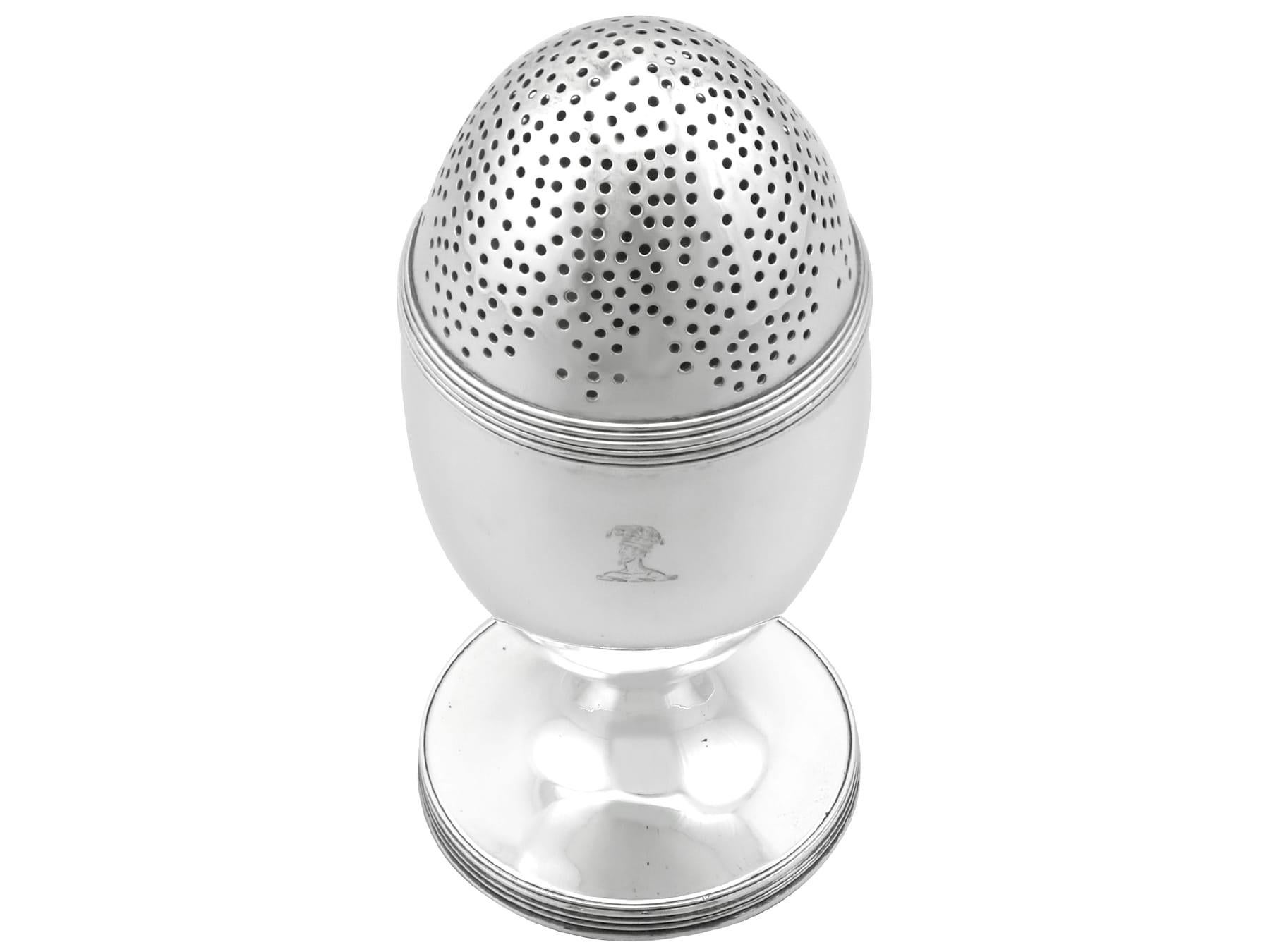 An exceptional, fine and impressive antique George III English sterling silver condiment caster/muffineer; an addition to our Georgian silverware collection.

This exceptional and large antique Georgian sterling silver sugar caster has an ovoid