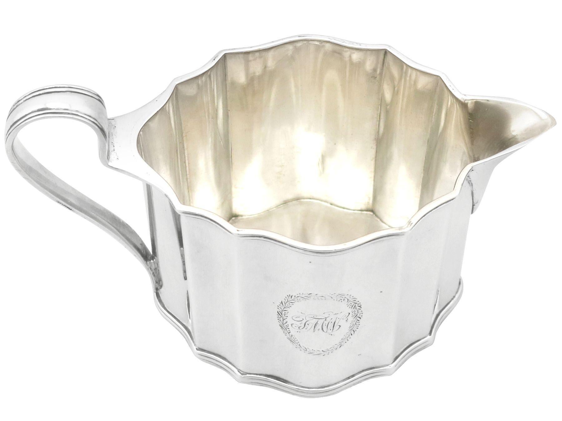 A fine and impressive, large antique George III English sterling silver cream jug made by Henry Chawner, an addition to our Georgian silver teaware collection.

This fine antique George III sterling silver cream jug has an oval shaped form.

The