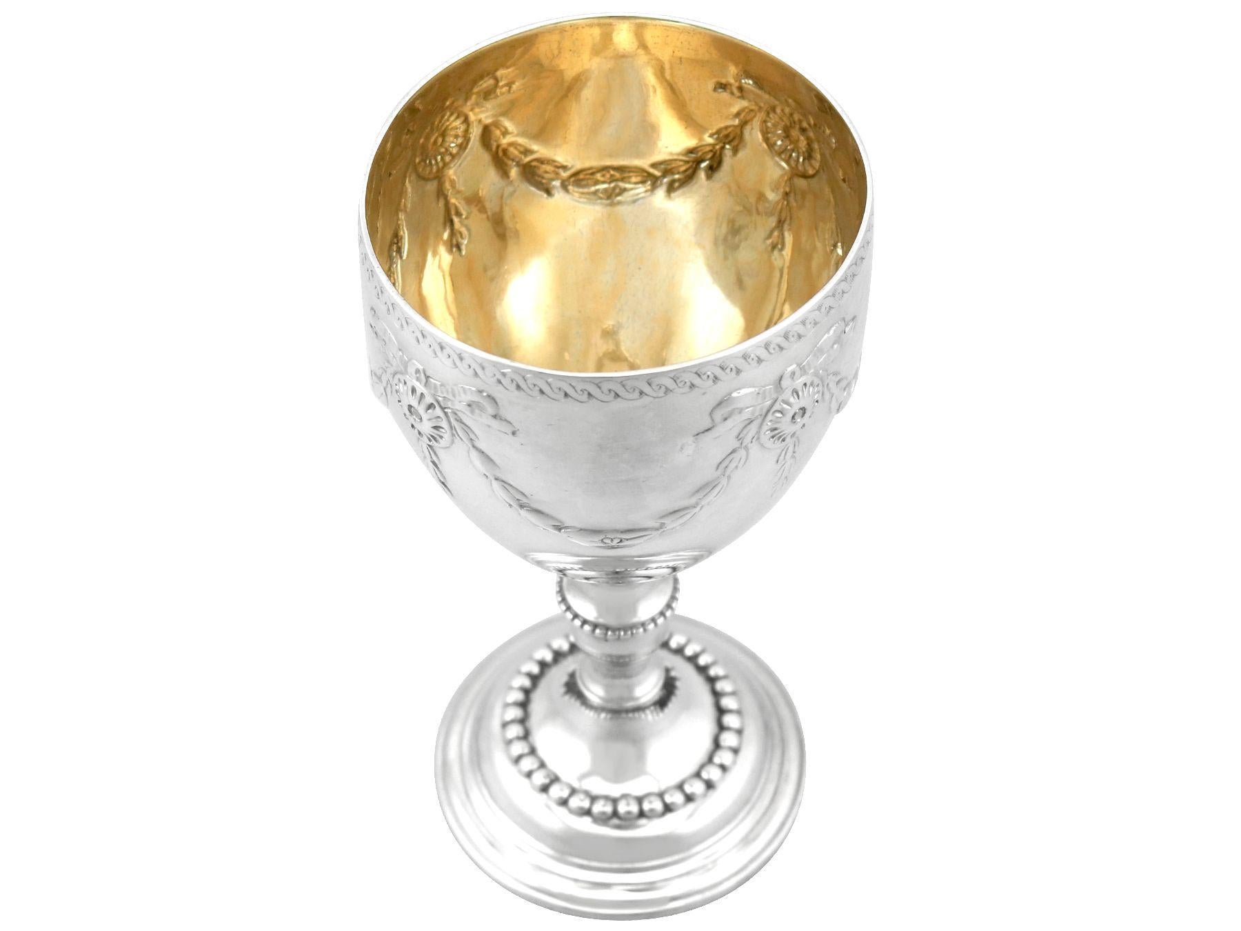 large gold or silver cup with a stem crossword clue