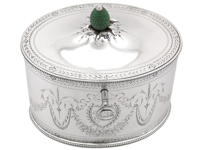 An exceptional, fine and impressive antique Georgian English sterling silver locking tea caddy by Henry Chawner; an addition to our silver teaware collection.

This exceptional antique Georgian sterling silver tea caddy has an oval form.

The