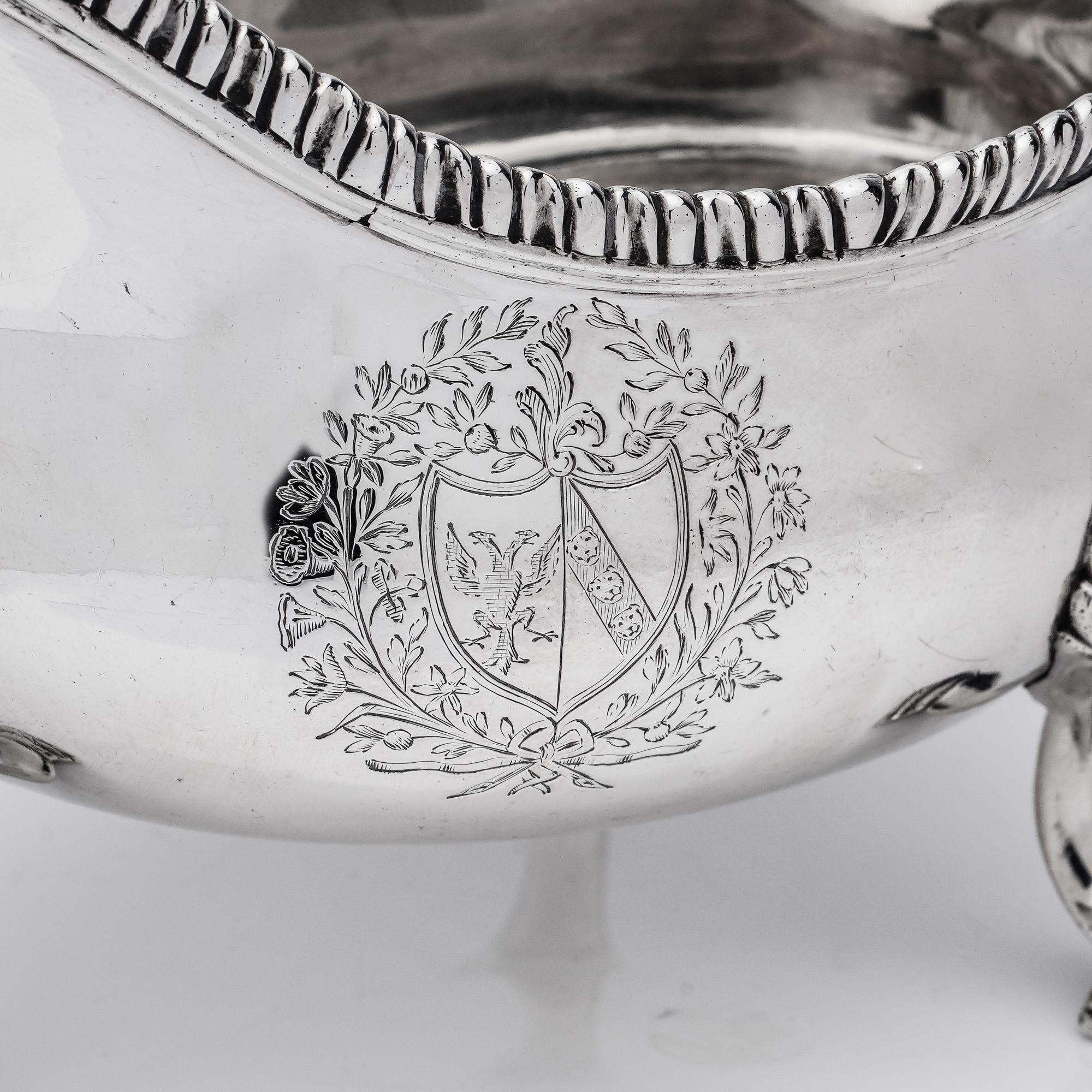 Antique George III sterling silver pair of sauce boats with coat of arms. 
Maker: George Smith (II)
Made in London, 1767
Fully hallmarked.

Pair of sauce boats are oval shaped, with leaf-capped scroll handles, shell feet and gadroon borders,