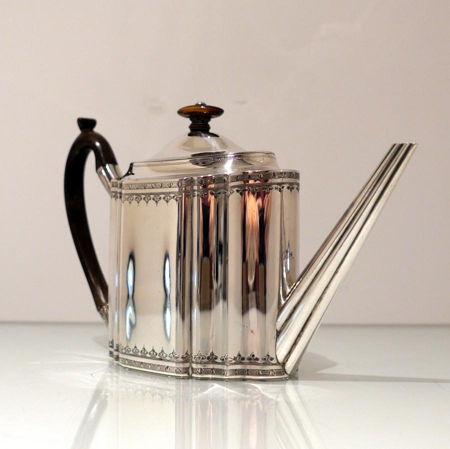 A superb quality shaped oval Georgian silver flush hinged teapot decorated with intricate bands of bright cut engraving and a splendidly designed straight fluted spout.

 Weight: 14 troy ounces/438 grams

Measures: Height 7
