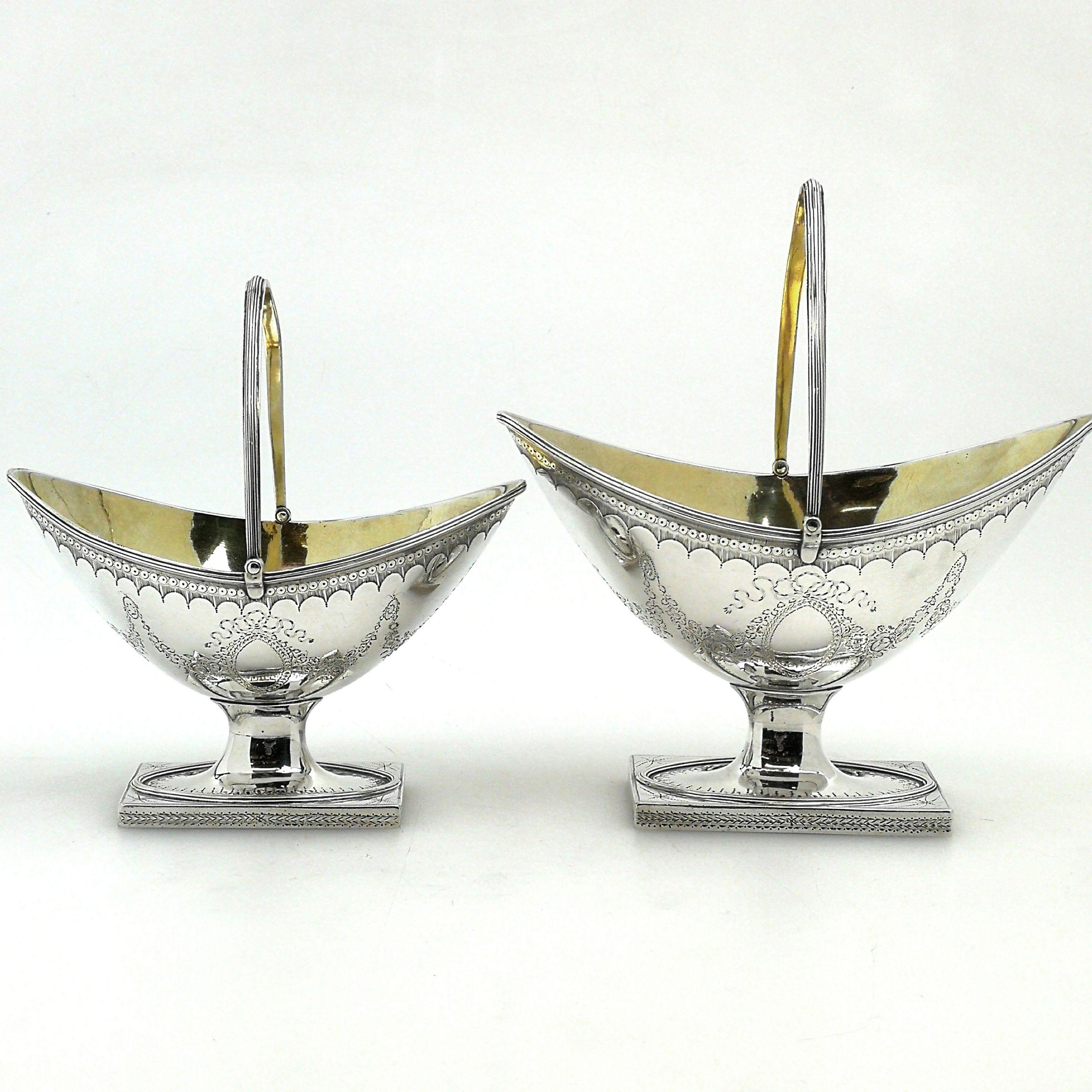 An antique Georgian George III solid Silver Sugar and Cream Set comprising of a Sugar Basket and a Cream Basket. This pair of Baskets is matched in design with the sugar basket being slightly larger than the cream basket. The oval Baskets stand on