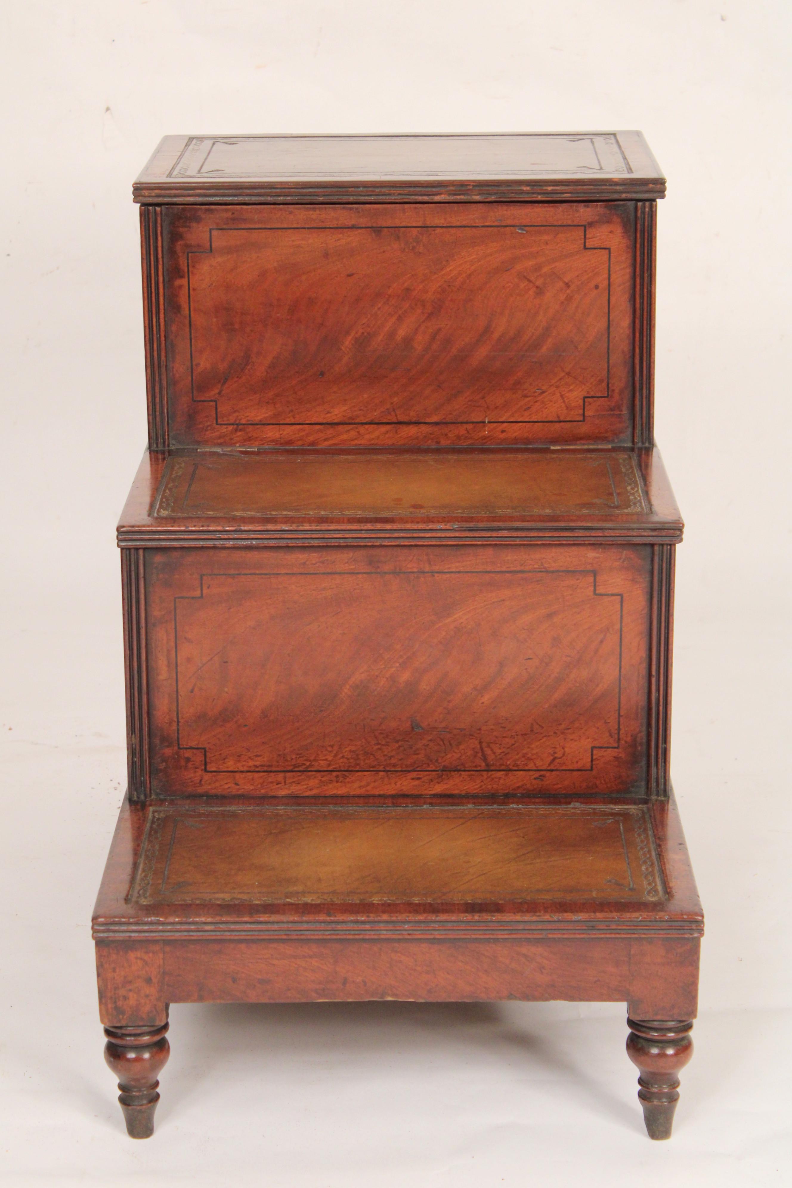 Antique George III style mahogany and oak bedside commode, 19th century. With tooled leather steps, nicely figured mahogany panels on the front and oak sides. The top step is hinged and opens for storage the second step pulls out as can be seen in