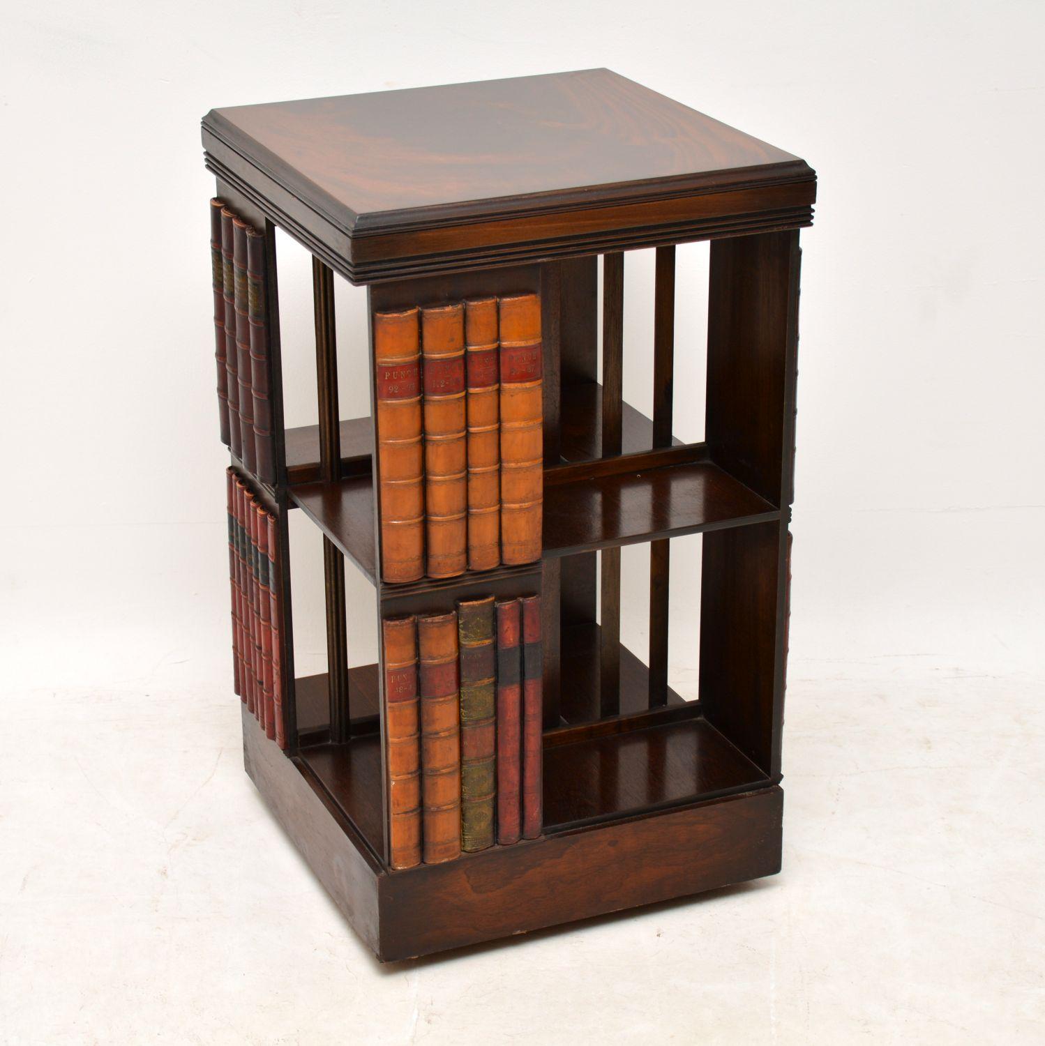 Antique George III style mahogany revolving bookstand with faux book decoration on all sections. This stand is in good original condition, having just been French polished and dates to around the 1950s period. The top is flame mahogany and there are