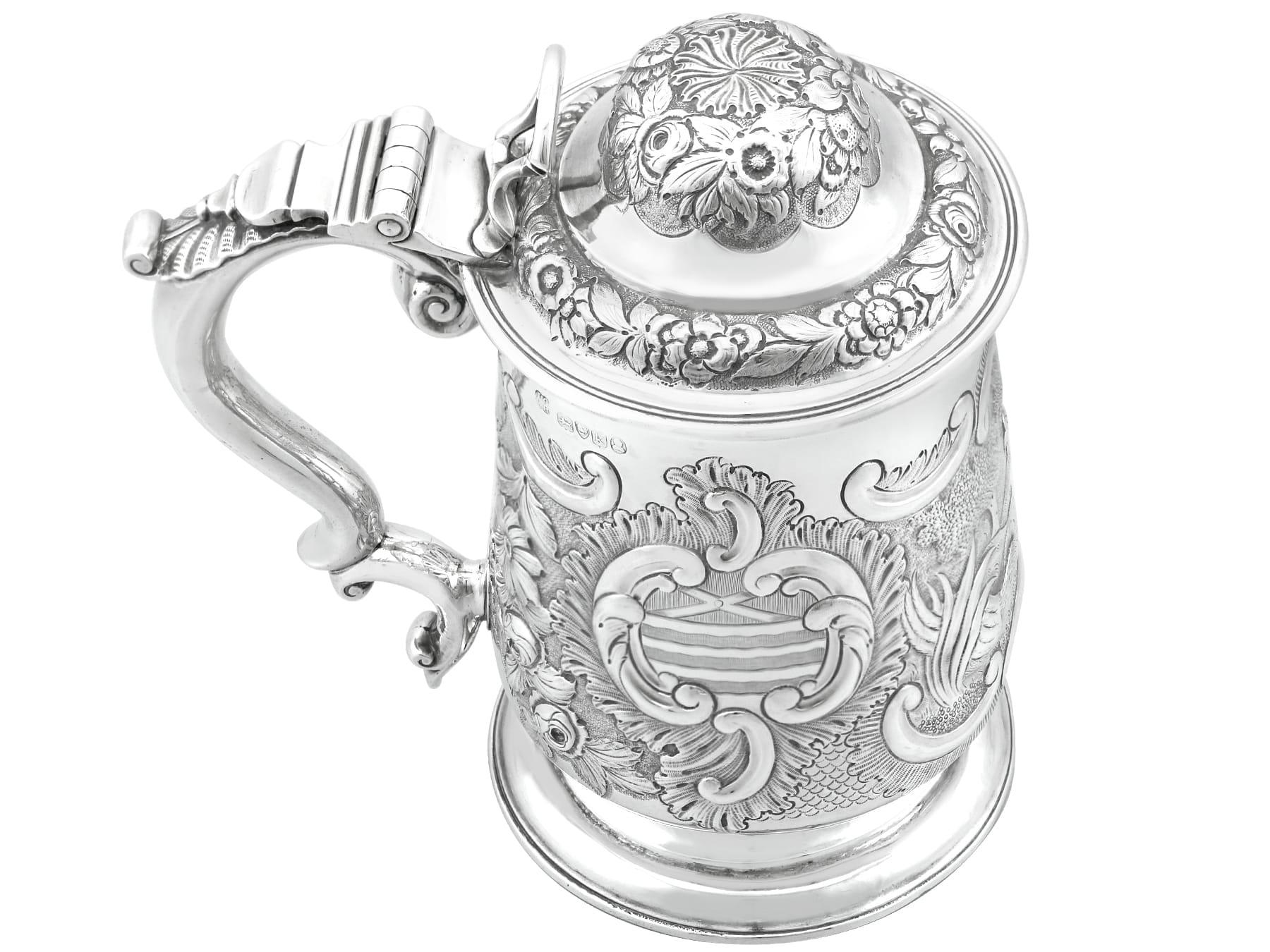 A fine and impressive antique George IV English sterling silver quart tankard; an addition to our silver tankard collection.

This exceptional antique George IV sterling silver quart tankard has a baluster form onto a plain spreading circular