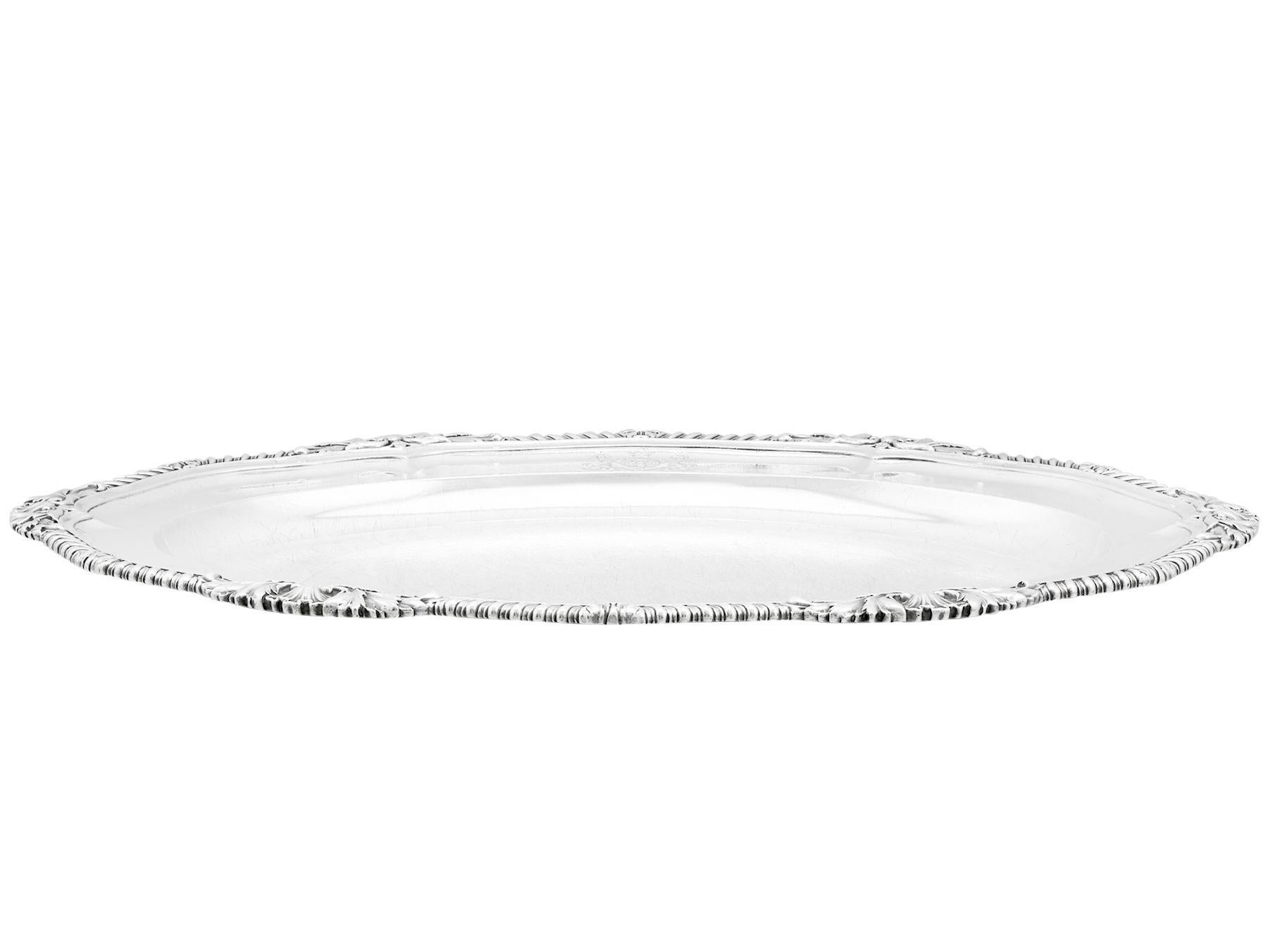 An exceptional, fine and impressive antique George IV English sterling silver platter made by Paul Storr, an addition to our dining silverware collection.

This exceptional antique George IV sterling silver serving platter by Paul Storr has an