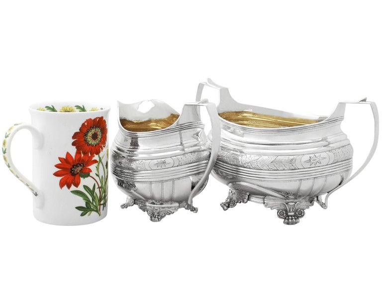 An exceptional, fine and impressive composite pair of antique George IV English sterling silver creamer and sugar bowl; an addition to our antique teaware collection.

This fine composite pair of antique George IV English sterling silver sugar