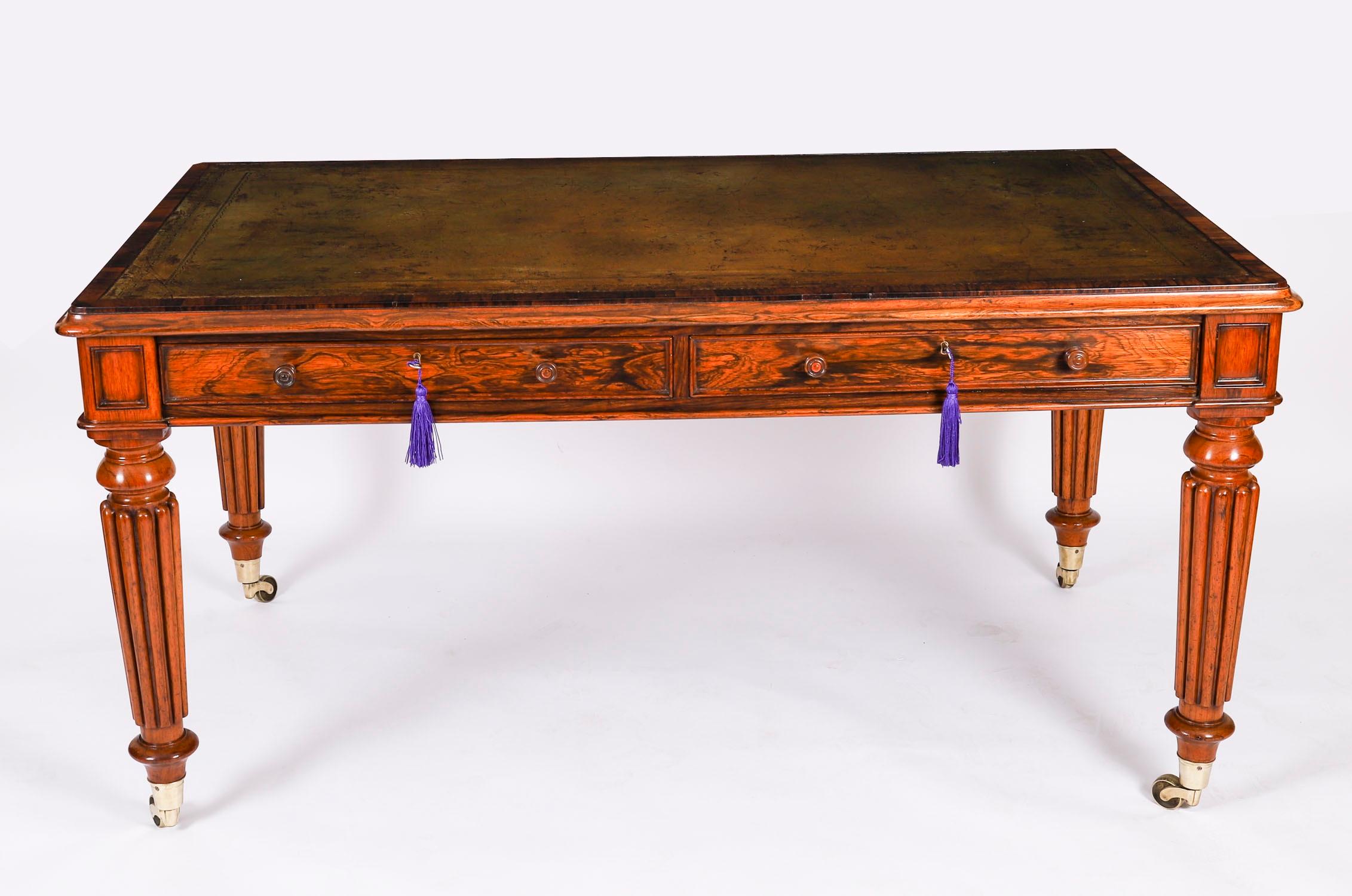 This monumental early George IV antique library writing table is crafted from beautiful Gonçalo Alves  and dates from Circa 1820.

The rectangular top features a moulded edge with the original inset  tanny green leather writing surface that features
