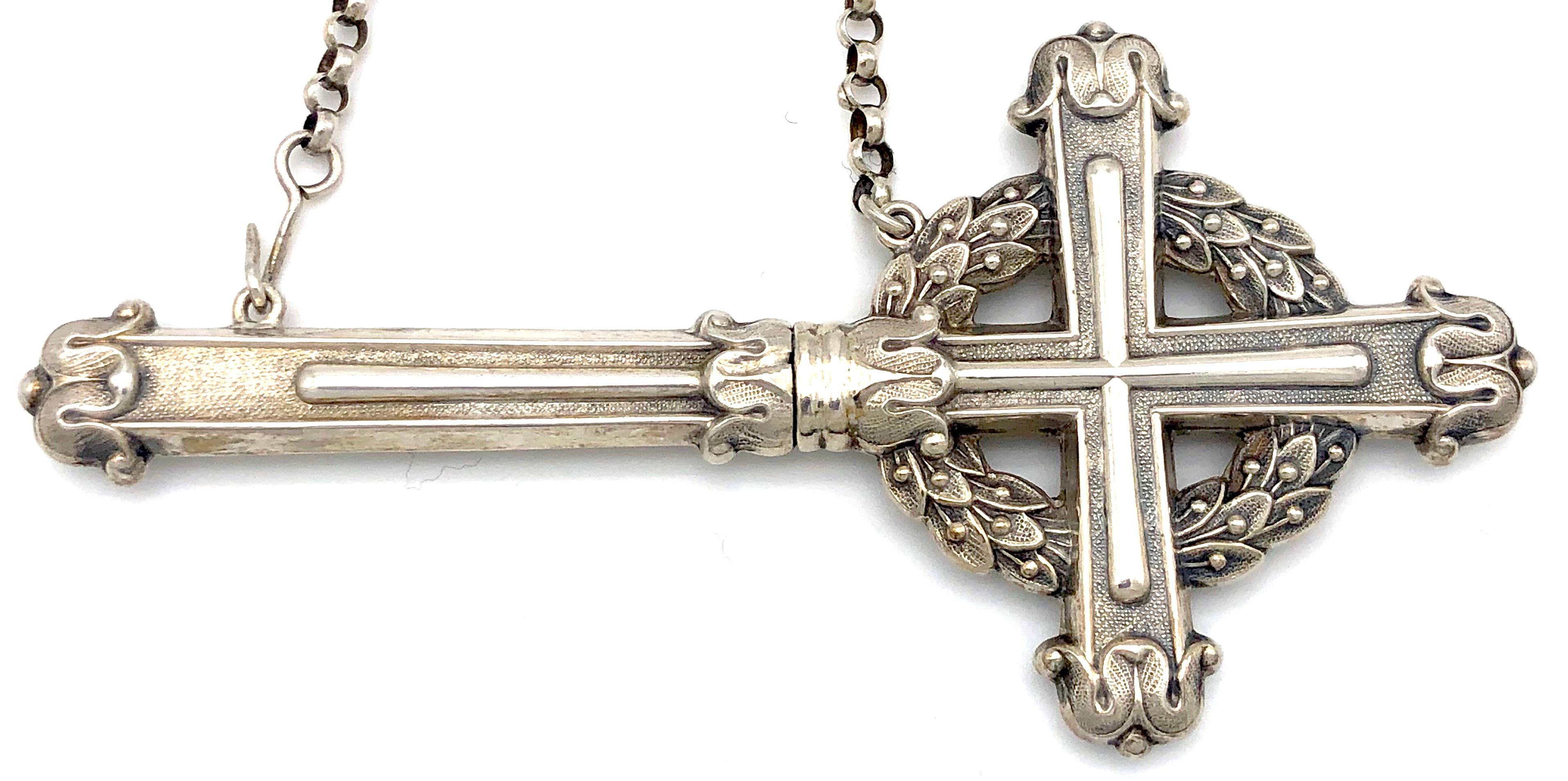 Very rare silver chatelaine with a needle case in the shape of a cross. The hook of the chatelaine is decorated with a  flower bouquet  ia vase.