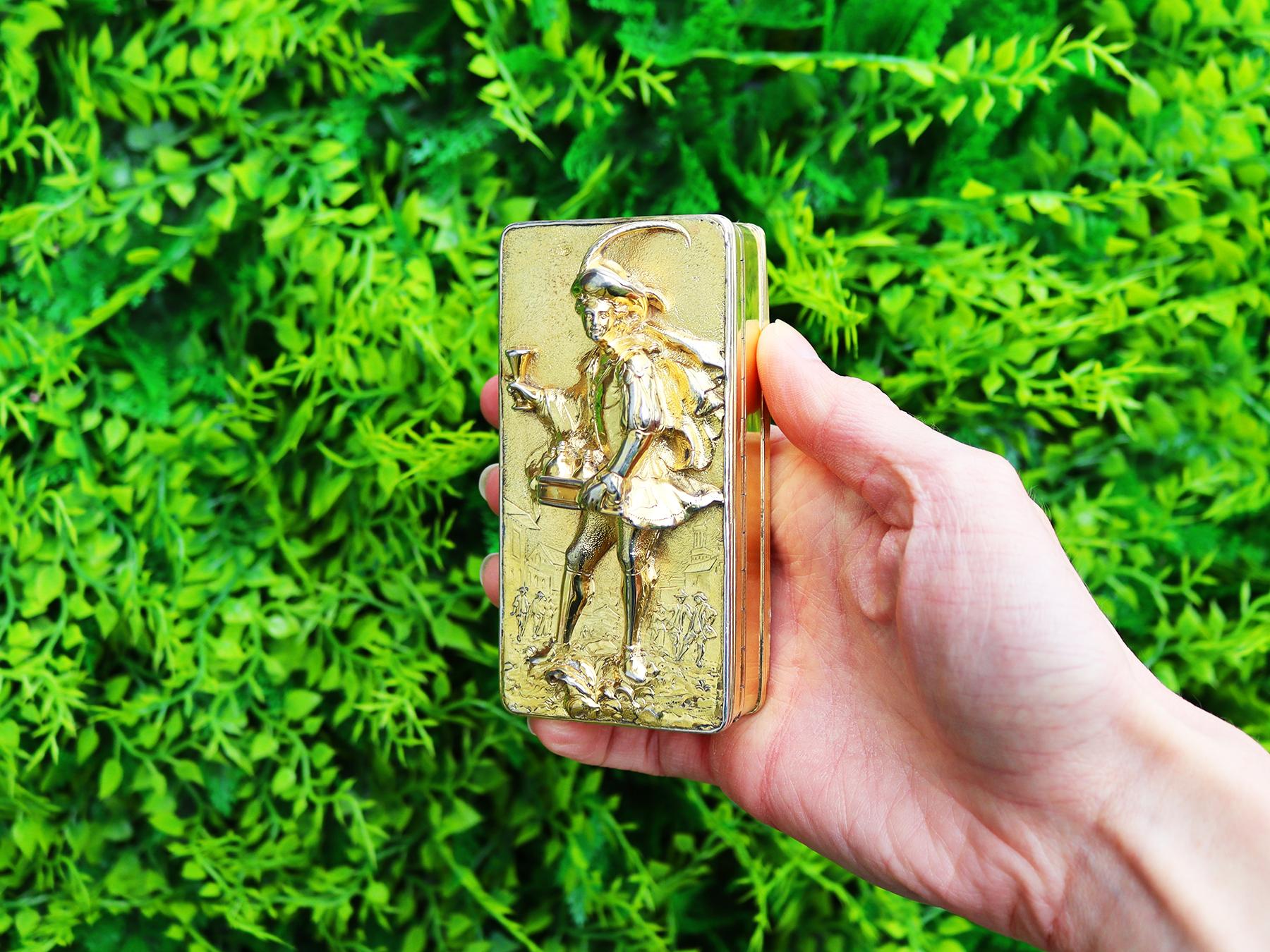 A magnificent, fine and impressive antique George IV English sterling silver gilt table snuff box; an addition to our antique box collection.

This magnificent antique George IV sterling silver gilt table snuff box has a rectangular form with