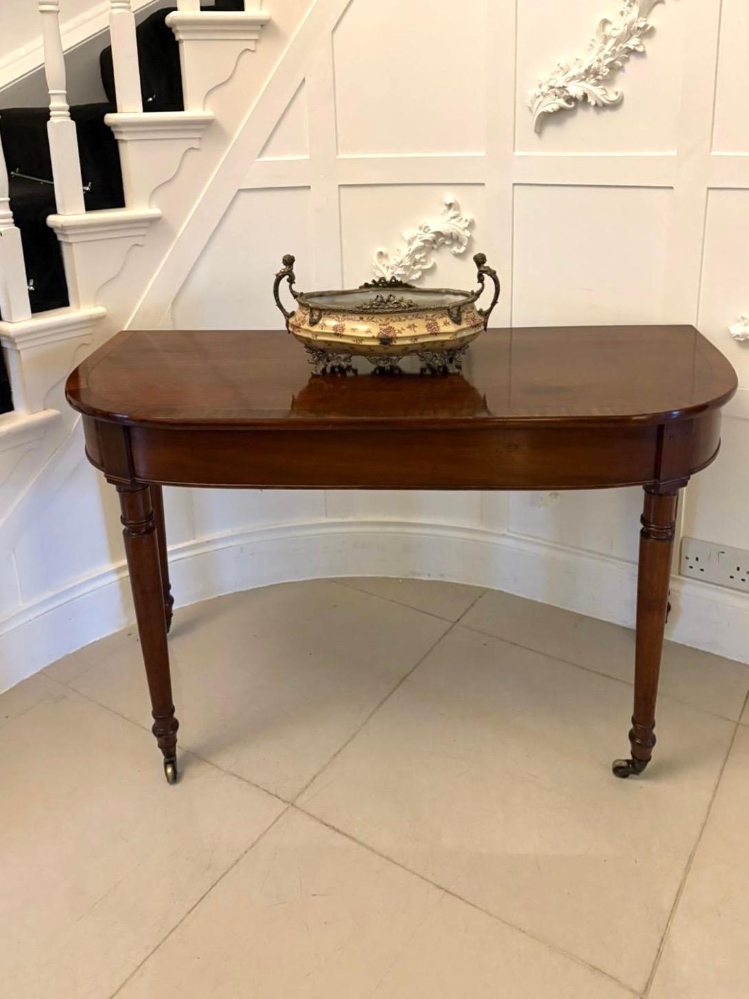 Antique George lII figured mahogany console table having a quality figured mahogany top with a crossbanded edge above a mahogany frieze standing on four elegant turned tapering legs with original brass cup castors 

A lovely example boasting a