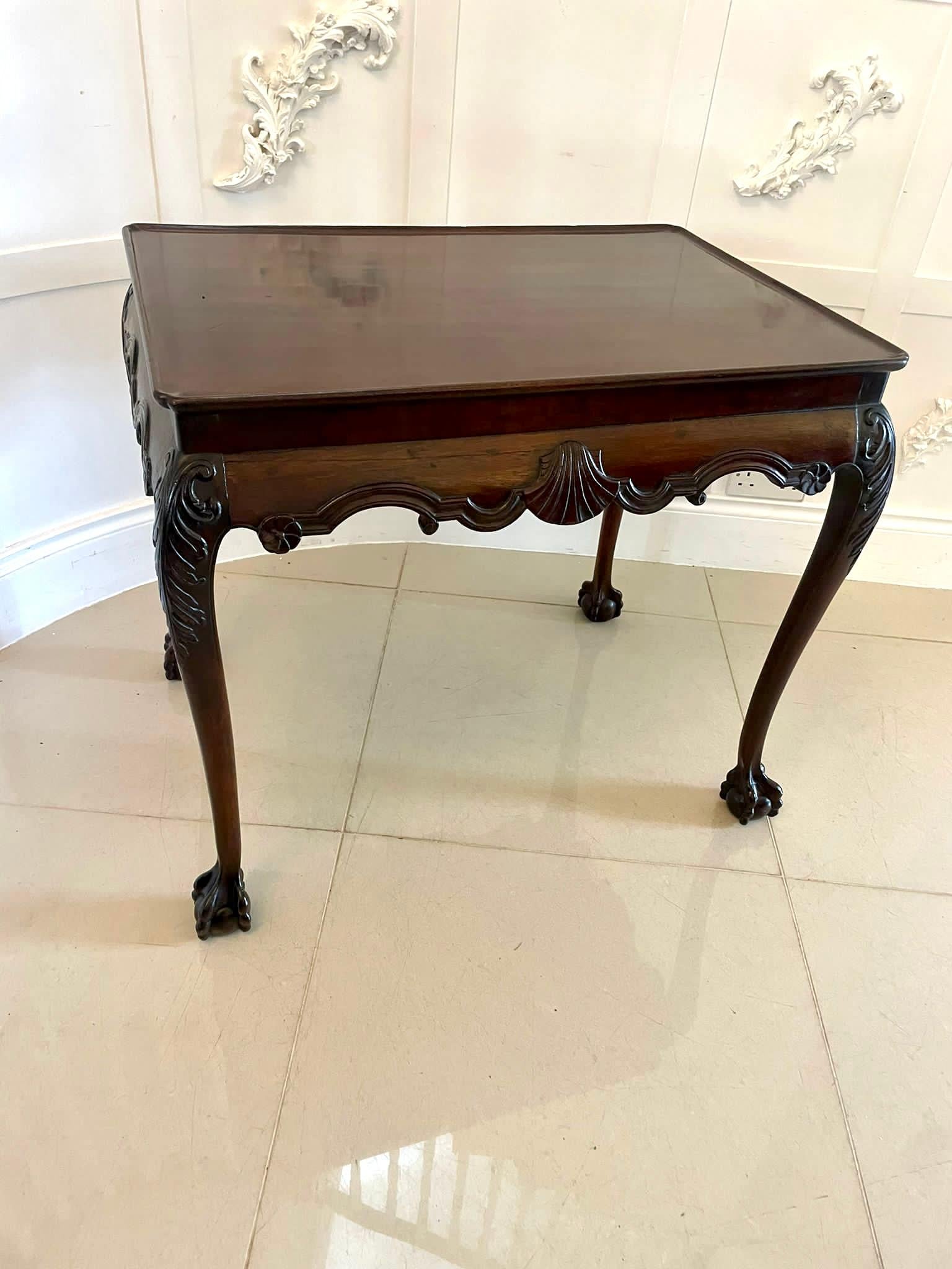 Antique George lII quality carved mahogany Irish silver table having a quality rectangular shaped mahogany dished top with re-entrant corners, exquisite serpentine shaped frieze centred by a carved shell standing on shaped cabriole legs with